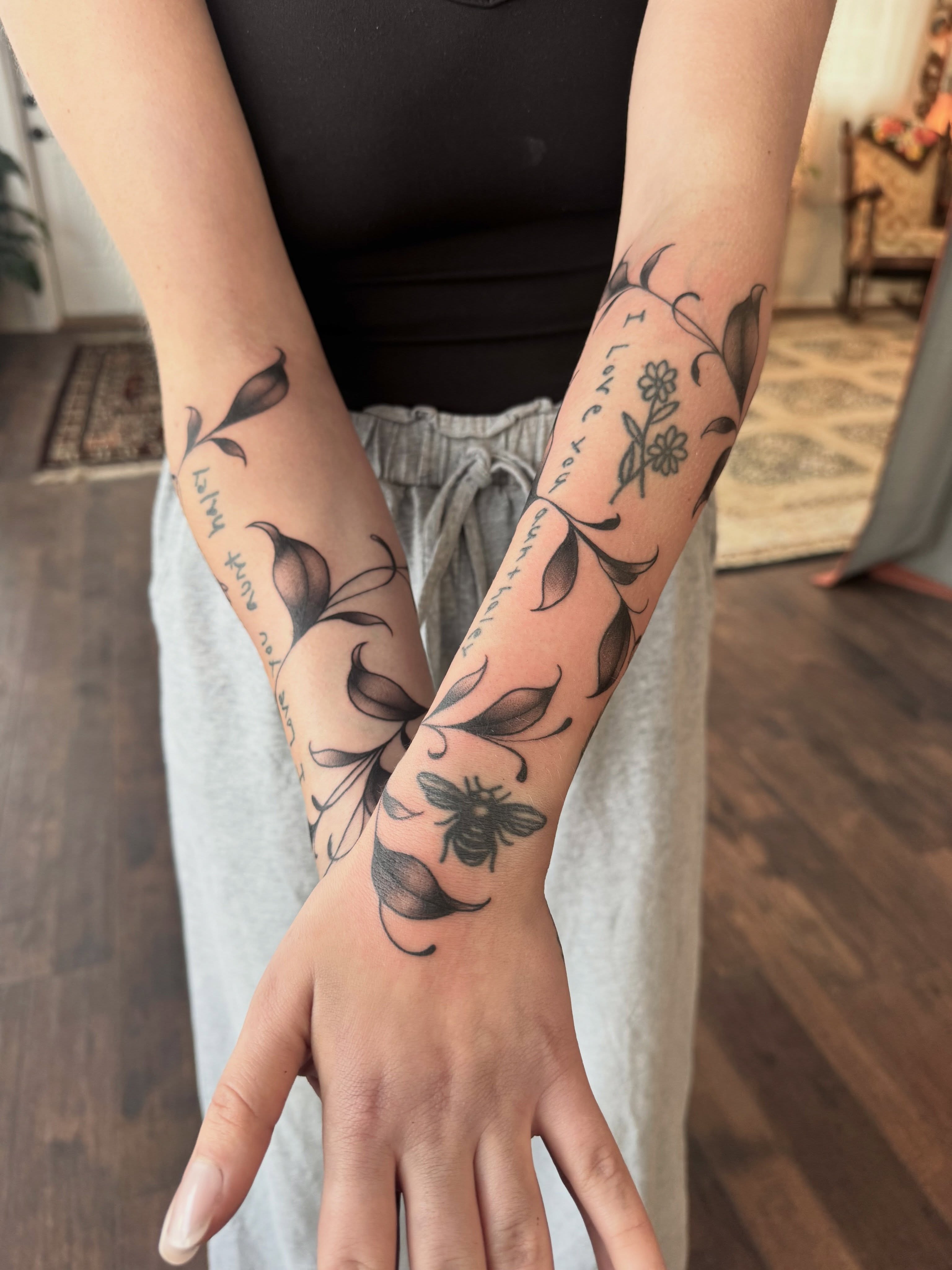 Floral and bee black and grey tattoo on the forearm by Alisa (Li) Affatato ๐ผ