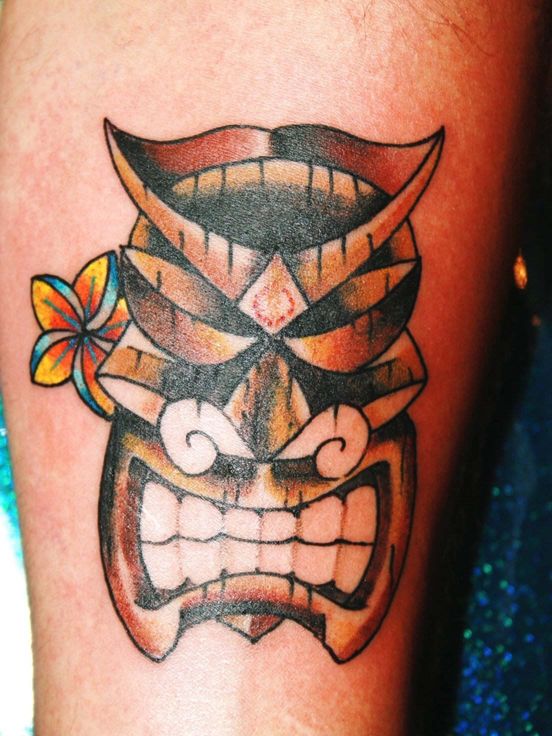 Tiki mask American traditional tattoo on the forearm by El Kapitan