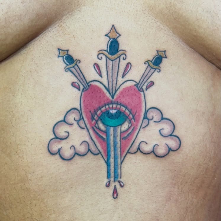 Heart with eye and swords American traditional tattoo on the chest by 🌛 𐌀𐌋𐌄𐋄𐌉𐌔 🌜