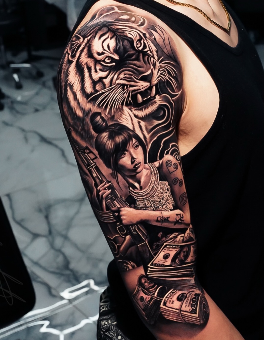 Chicano tattoo on the upper arm by George Lange