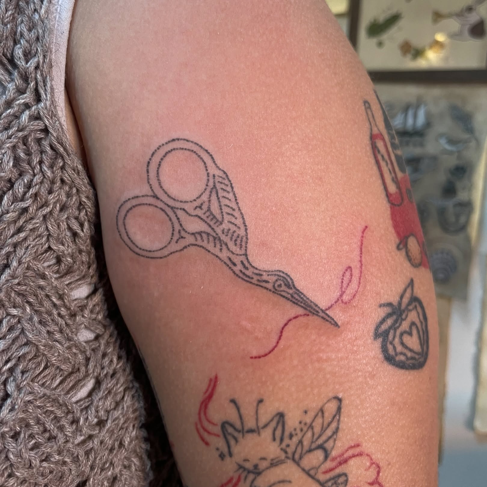 Scissors and thread black and grey tattoo on the forearm by Roe