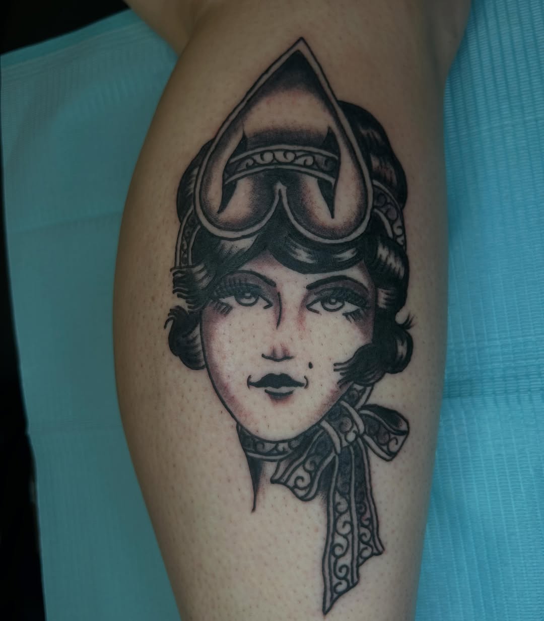 Woman with aviator helmet black and grey tattoo on the forearm by Casey Lewis - Tattoo Artist, Cleveland Ohio