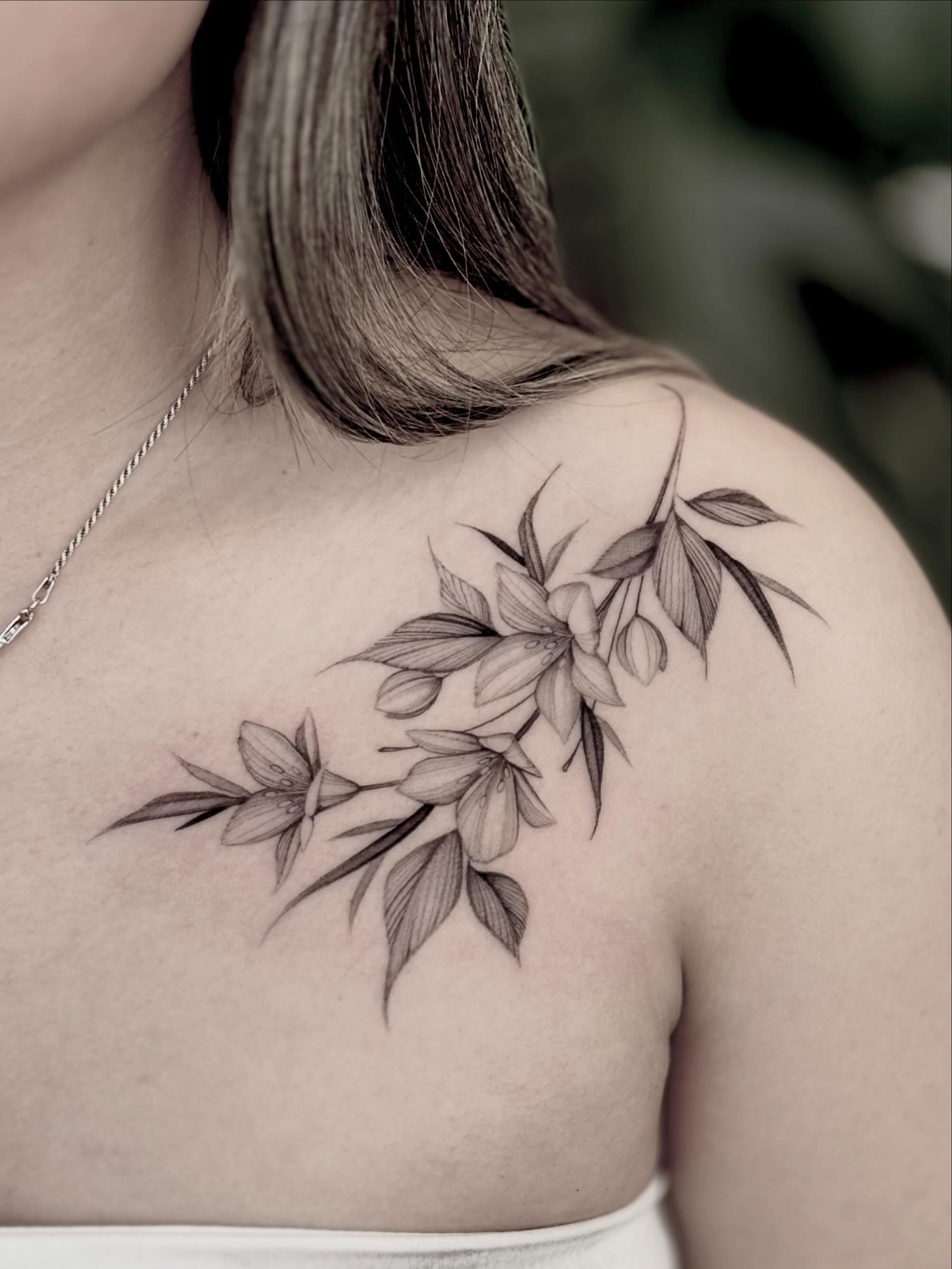 Flower branch black and grey tattoo on the shoulder by Brittney Naami, San Francisco, California