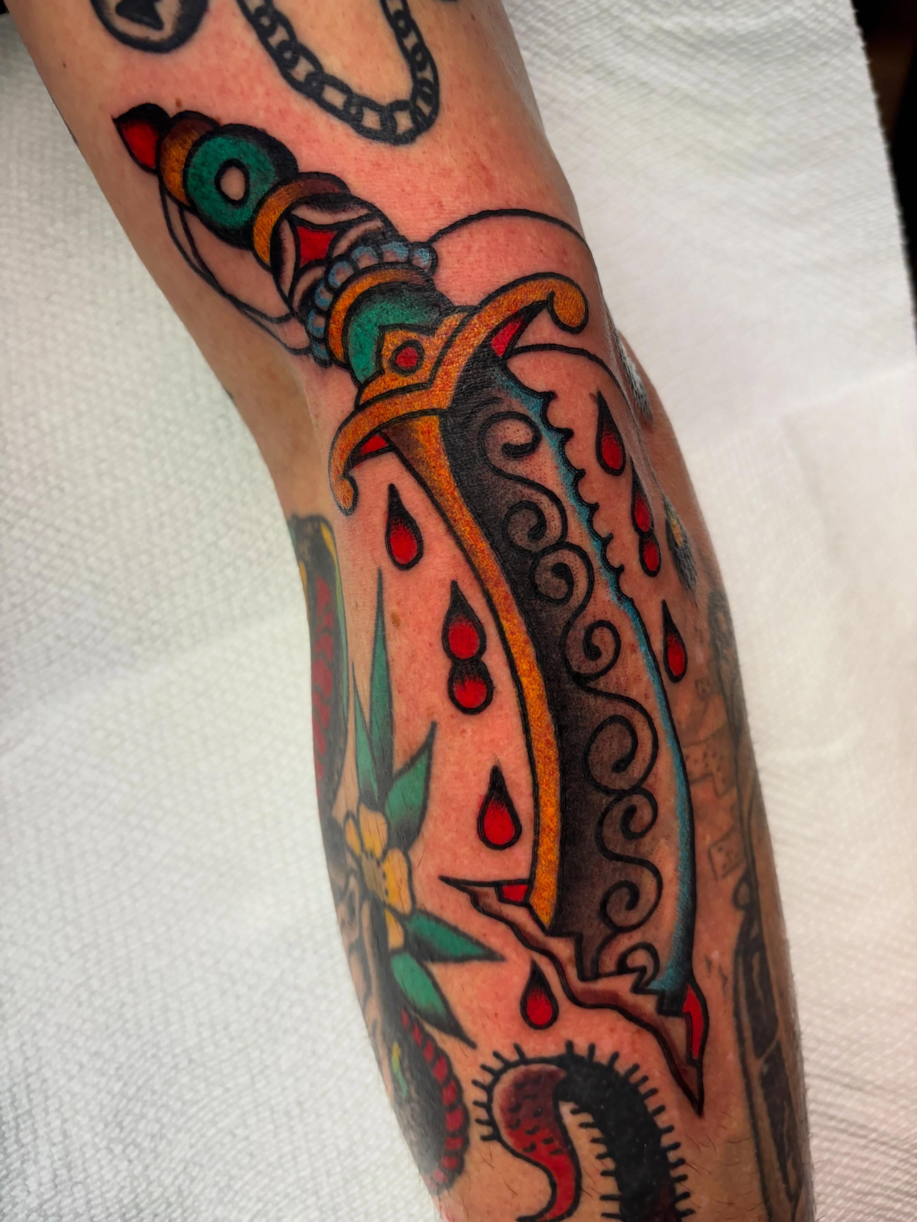 Sword and blood American traditional tattoo on the forearm by Chris Dufresne