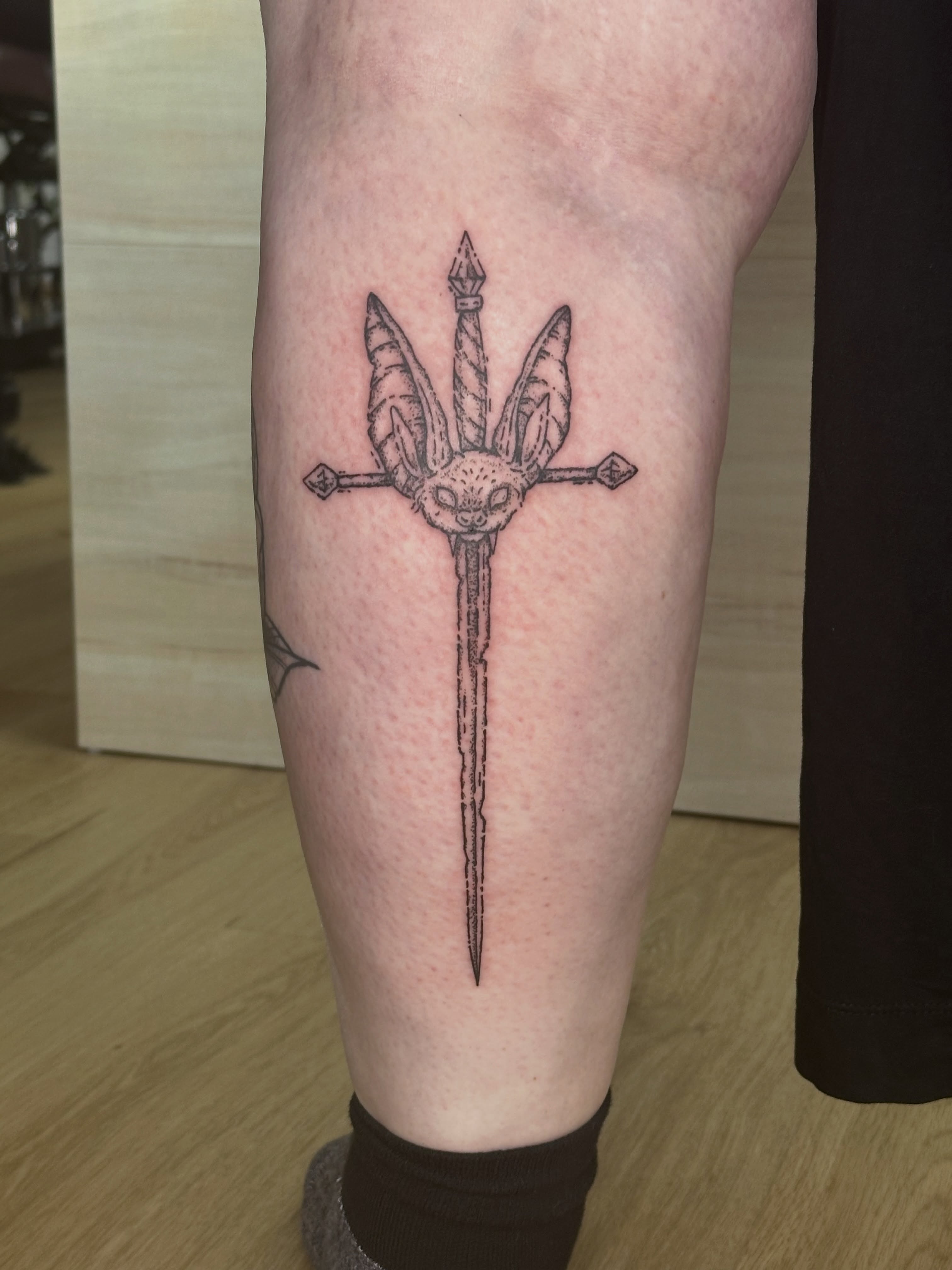 Bat and trident black and grey tattoo on the calf by Fleur ๐ฅ