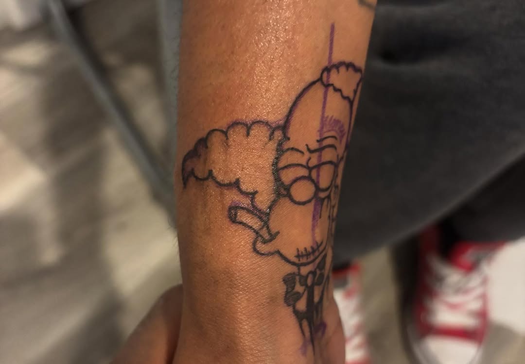 Krusty the Clown smoking tattoo on the forearm by Ink_ Hustle36