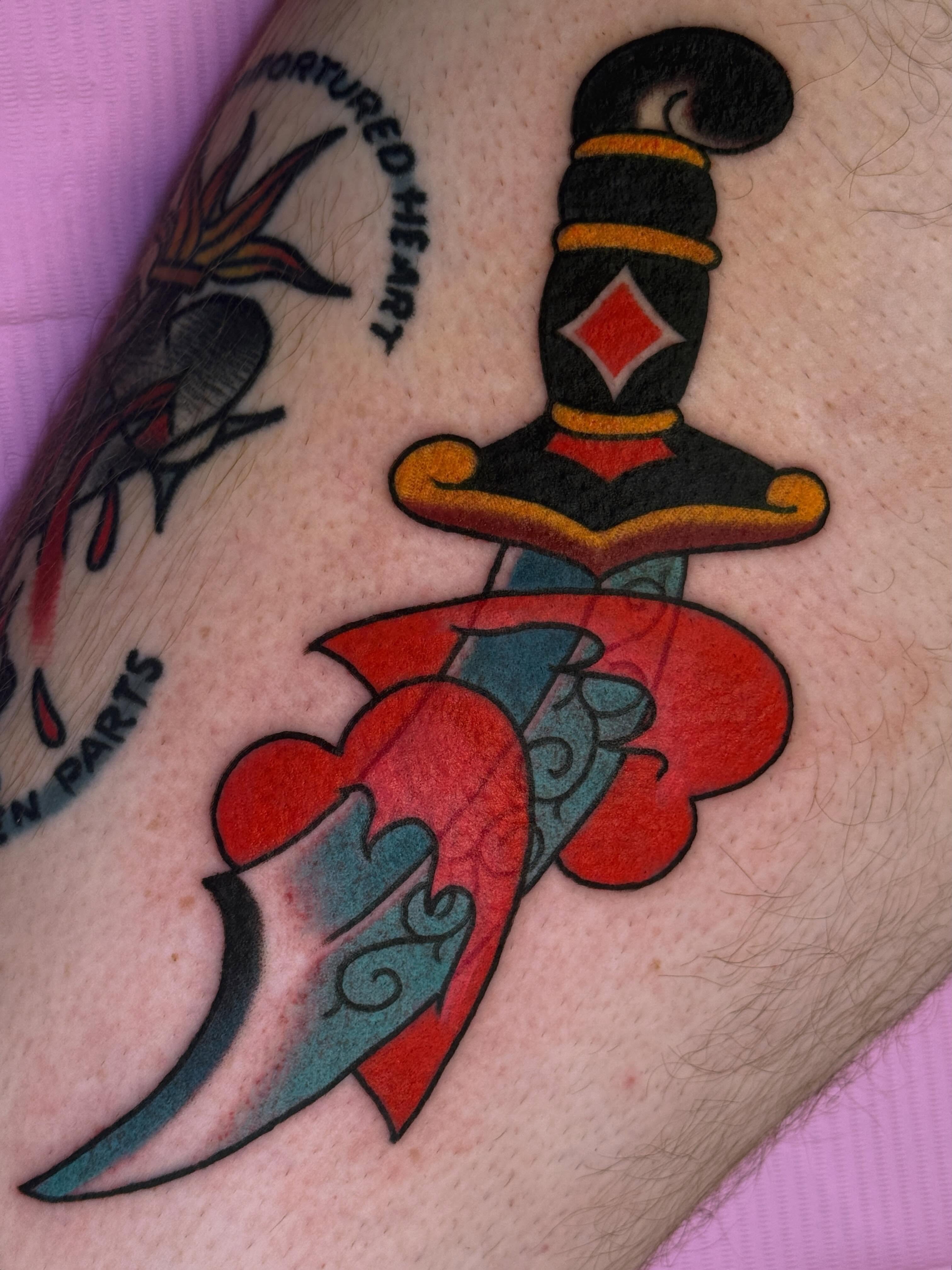 Heart and dagger American traditional tattoo on the forearm by Cassie O'Neal DeBord