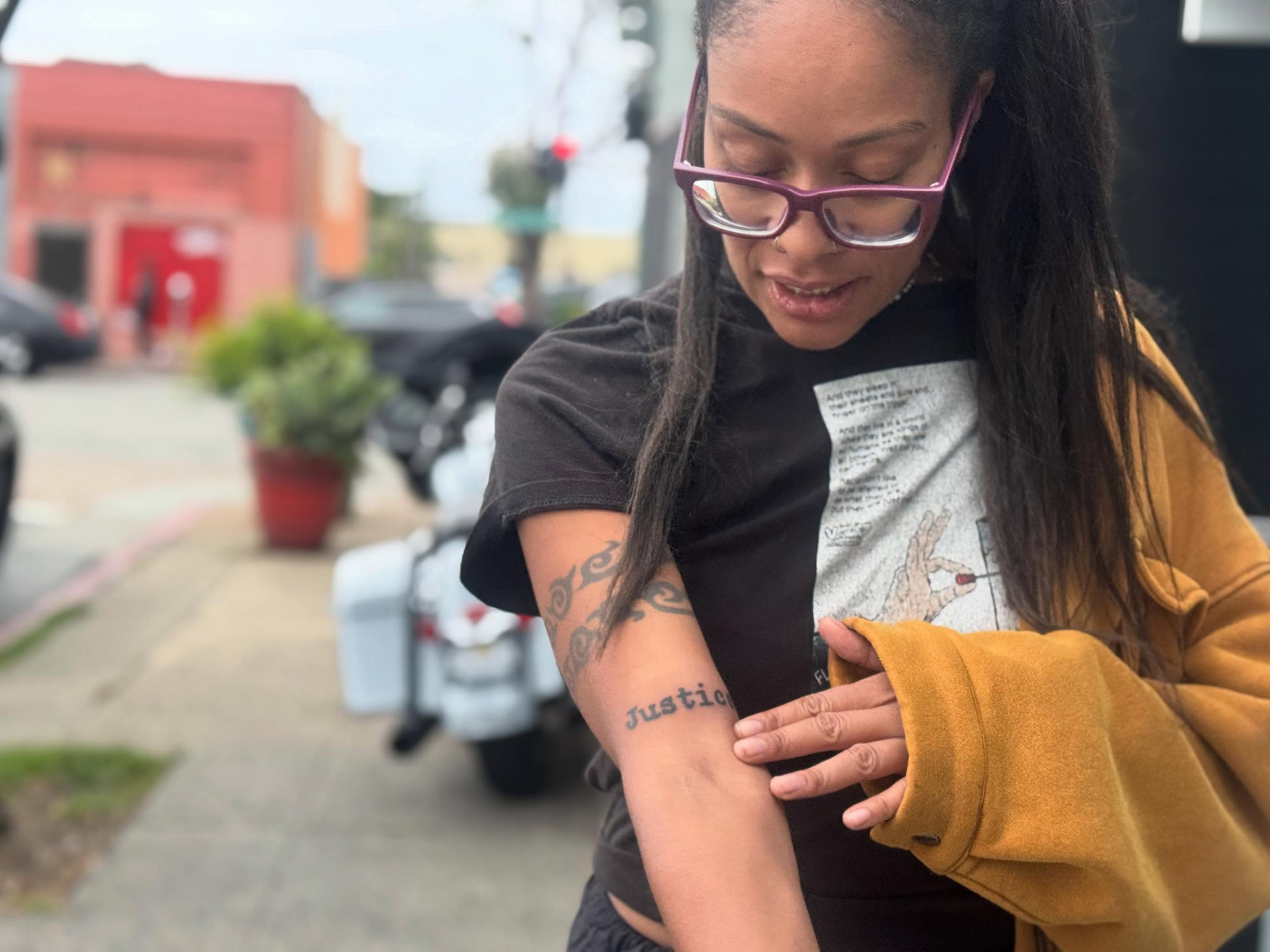 Justice lettering script tattoo on the forearm by Gabe