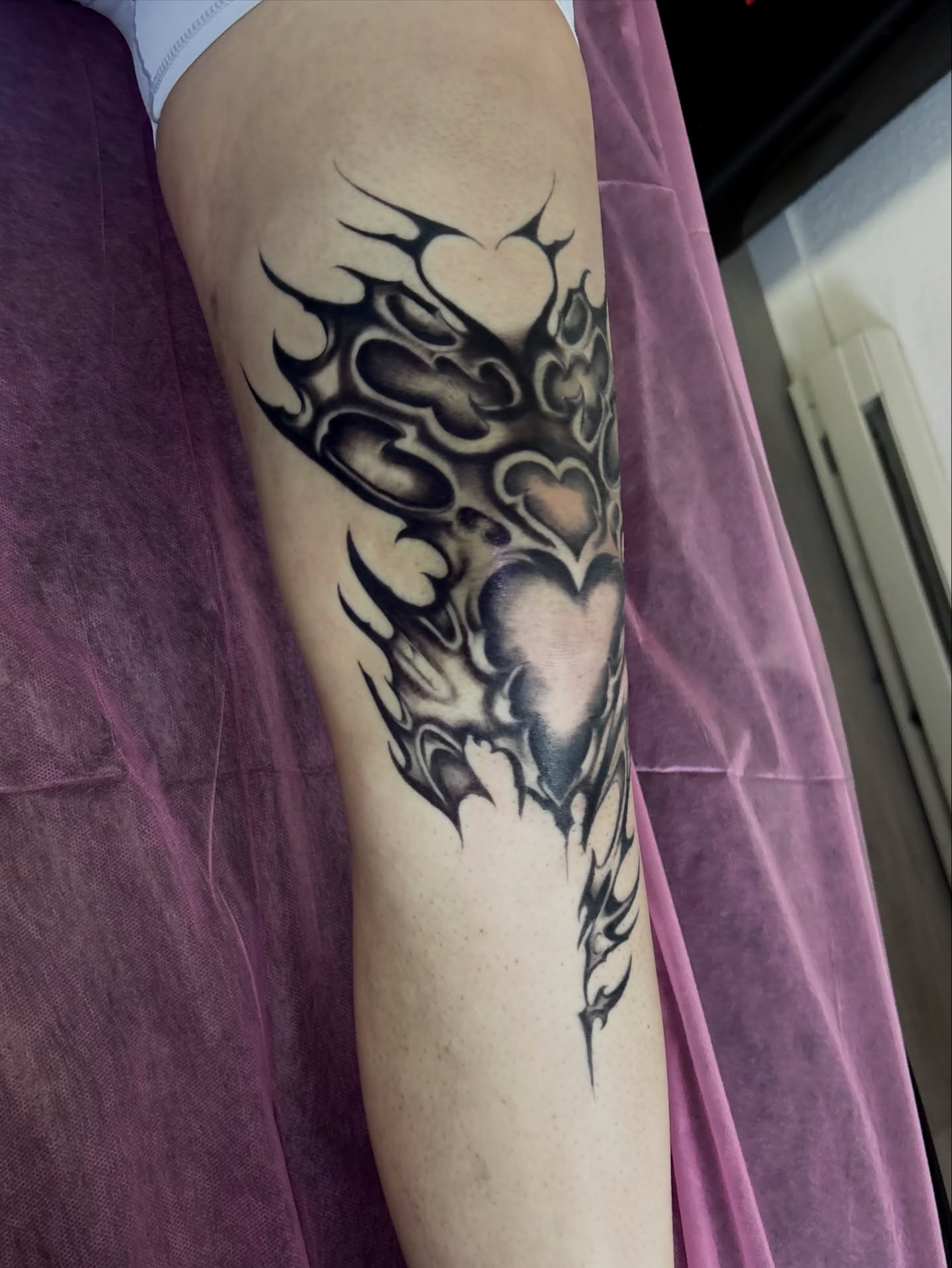 Hearts and flames tribal tattoo on the forearm by Elixabeth