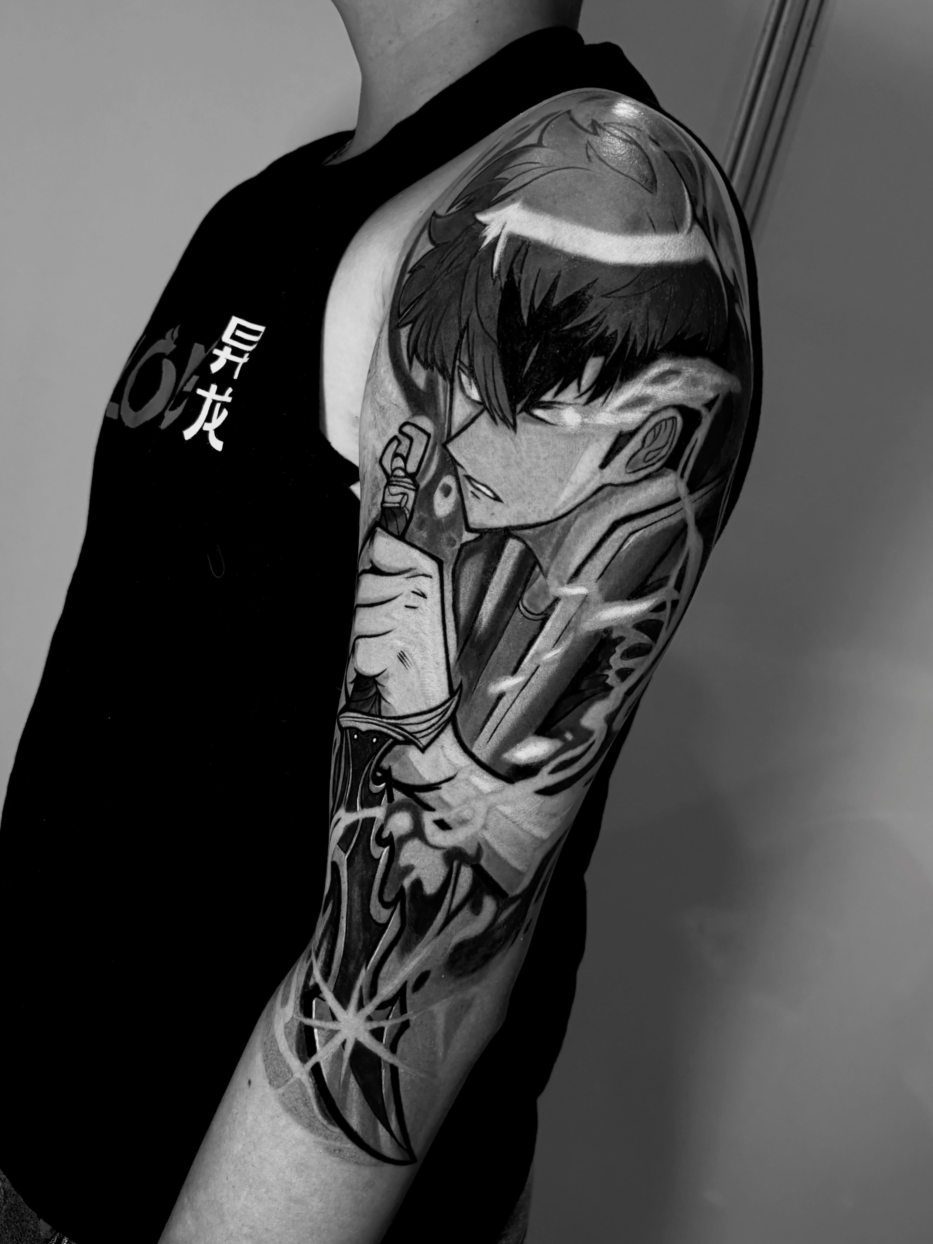 Anime character anime tattoo on the upper arm by Tattoo Medellin