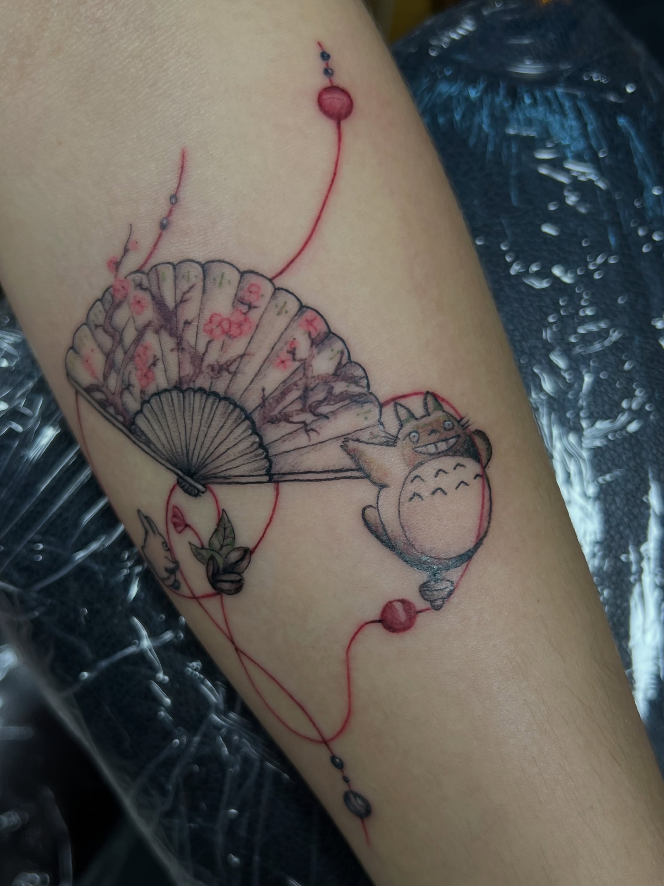 Totoro and fan dotwork tattoo on the forearm by Asap tattoo