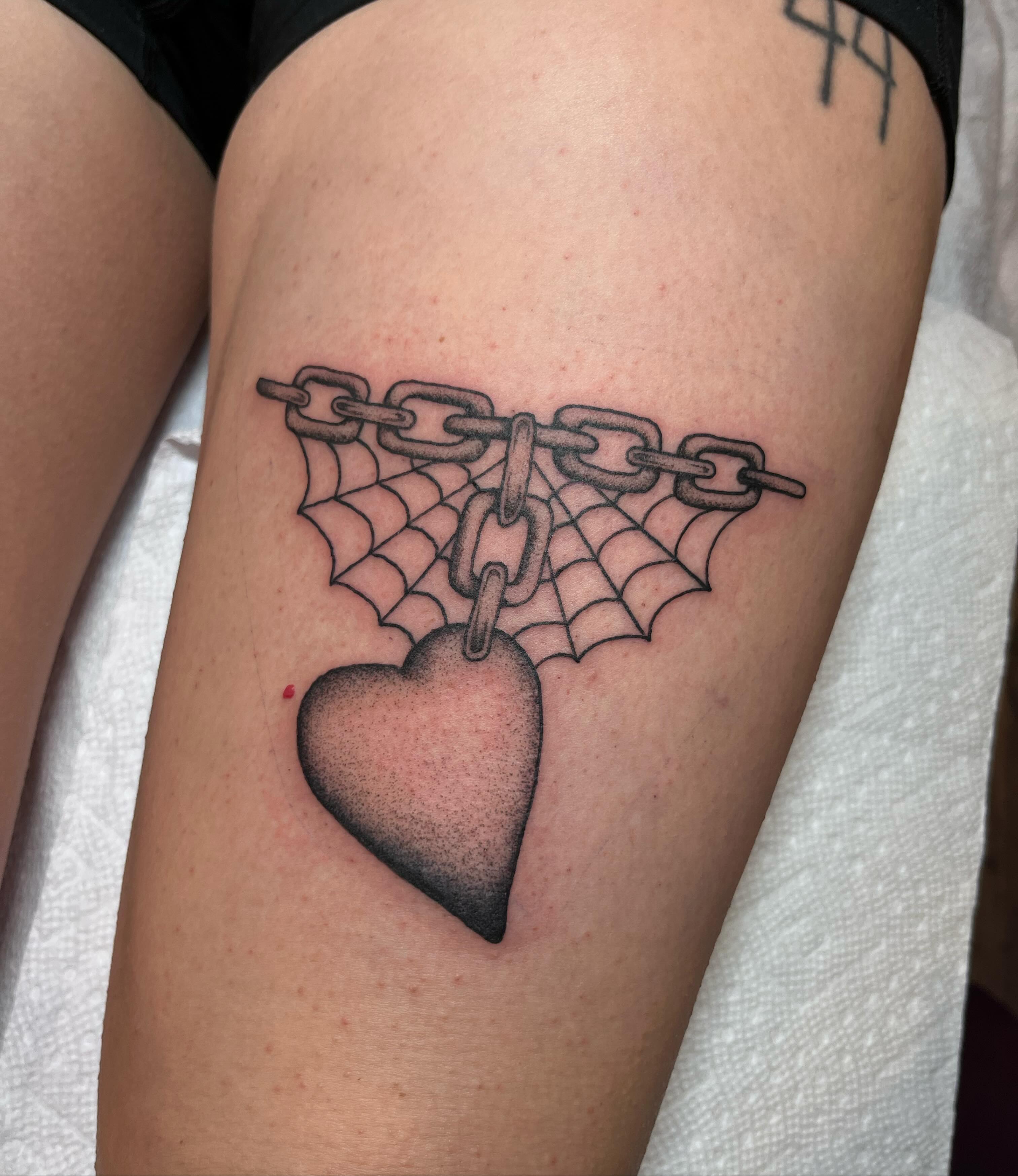 Heart with chains dotwork tattoo on the thigh by Jackson Kirchhoff