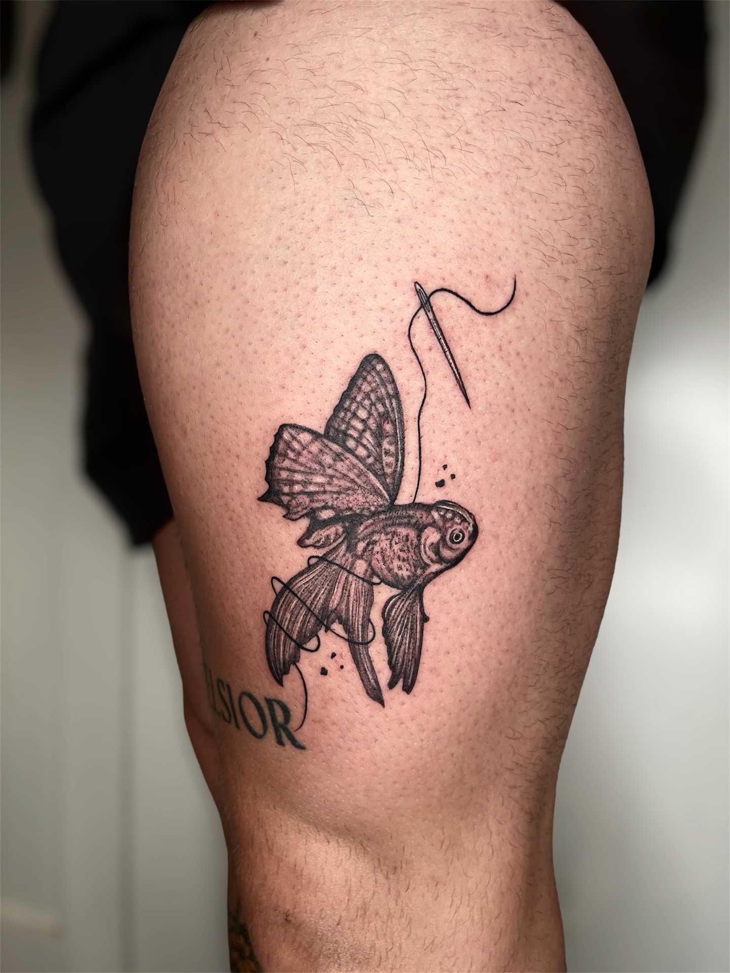 Goldfish black and grey tattoo on the thigh by Elisa