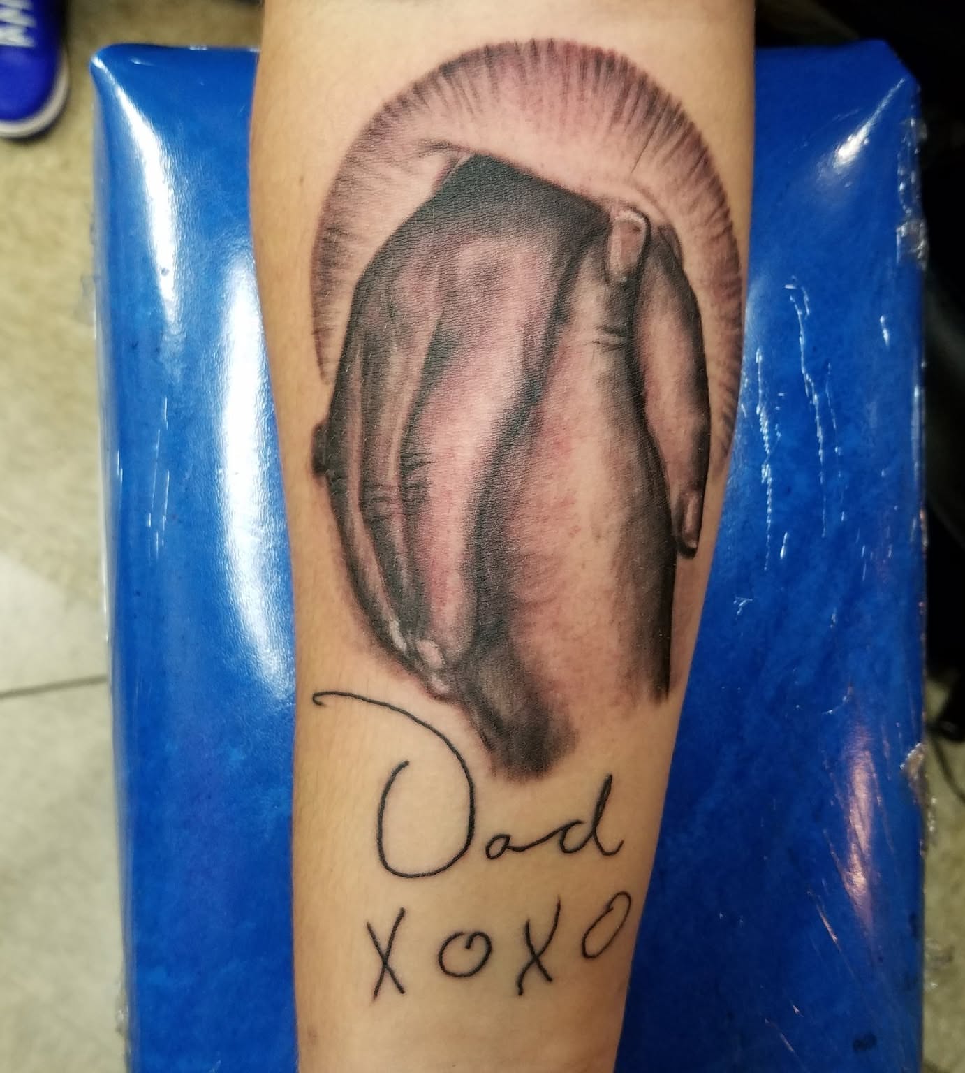 Hand in glove realism tattoo on the forearm by Oz Dillinger