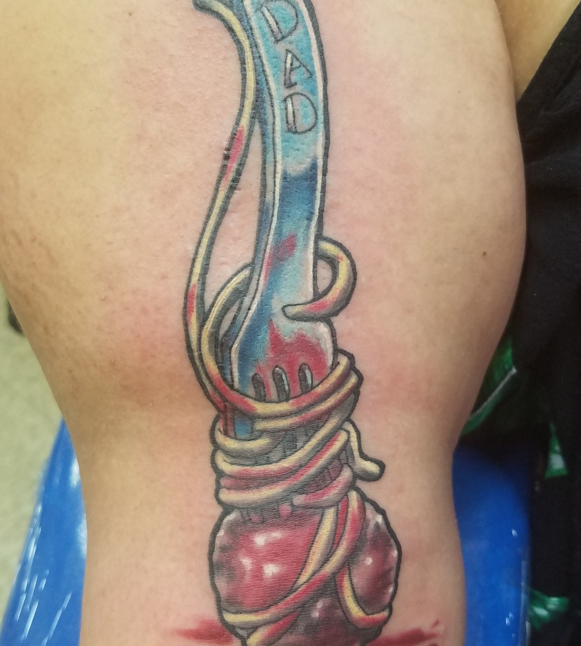 Knife and string realism tattoo on the thigh by Oz Dillinger