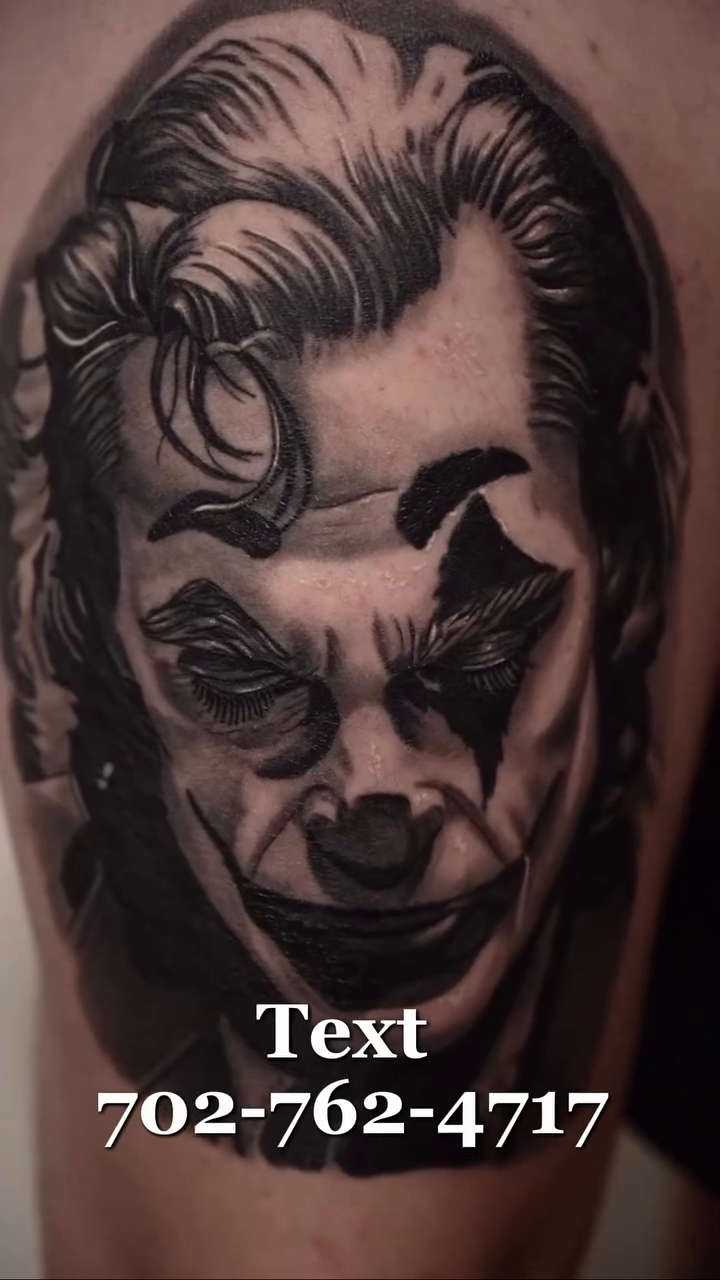 Joker portrait realism tattoo on the upper arm by Travis