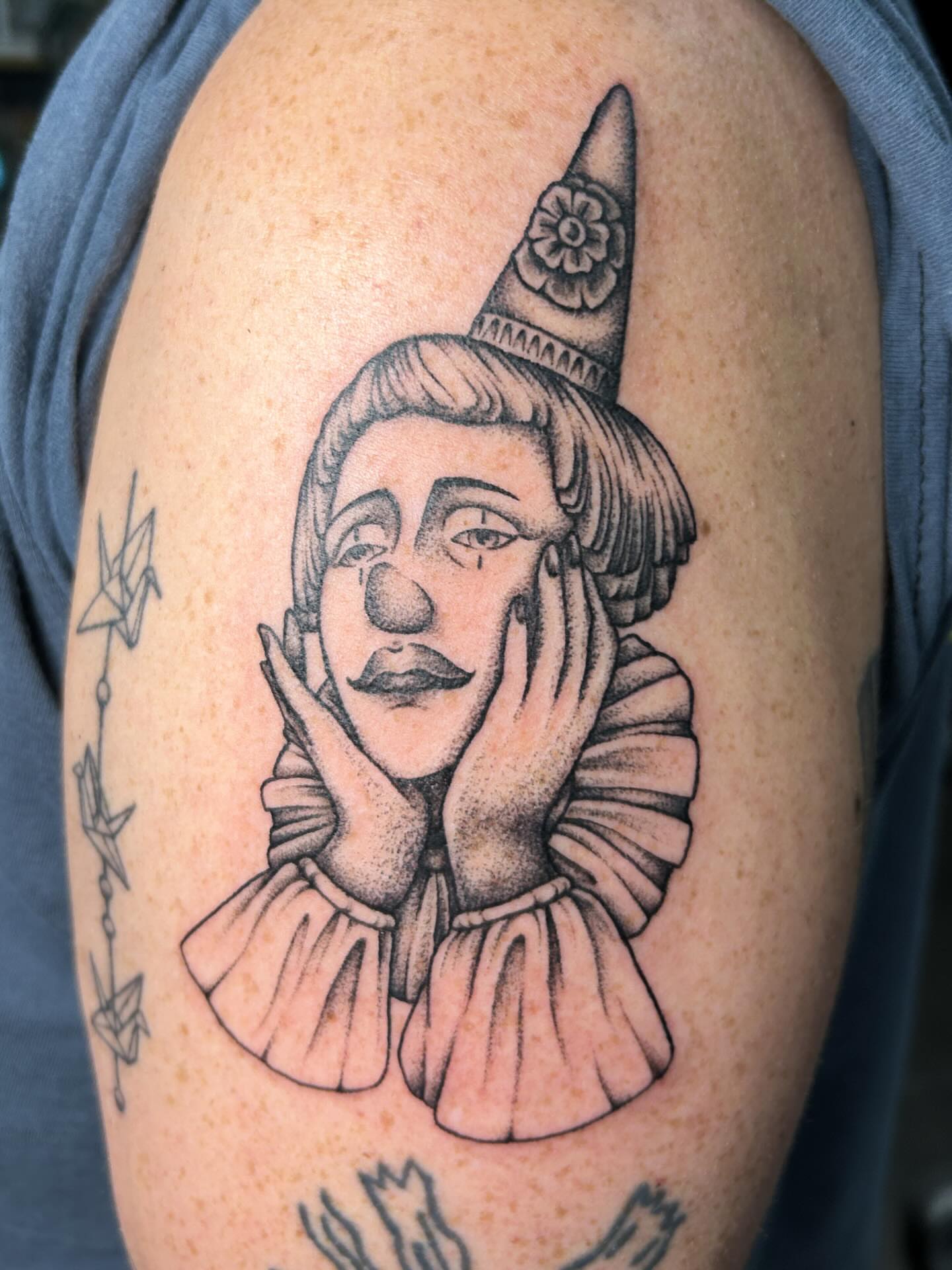 Clown portrait realism tattoo on the shoulder by Janelle McCarthy