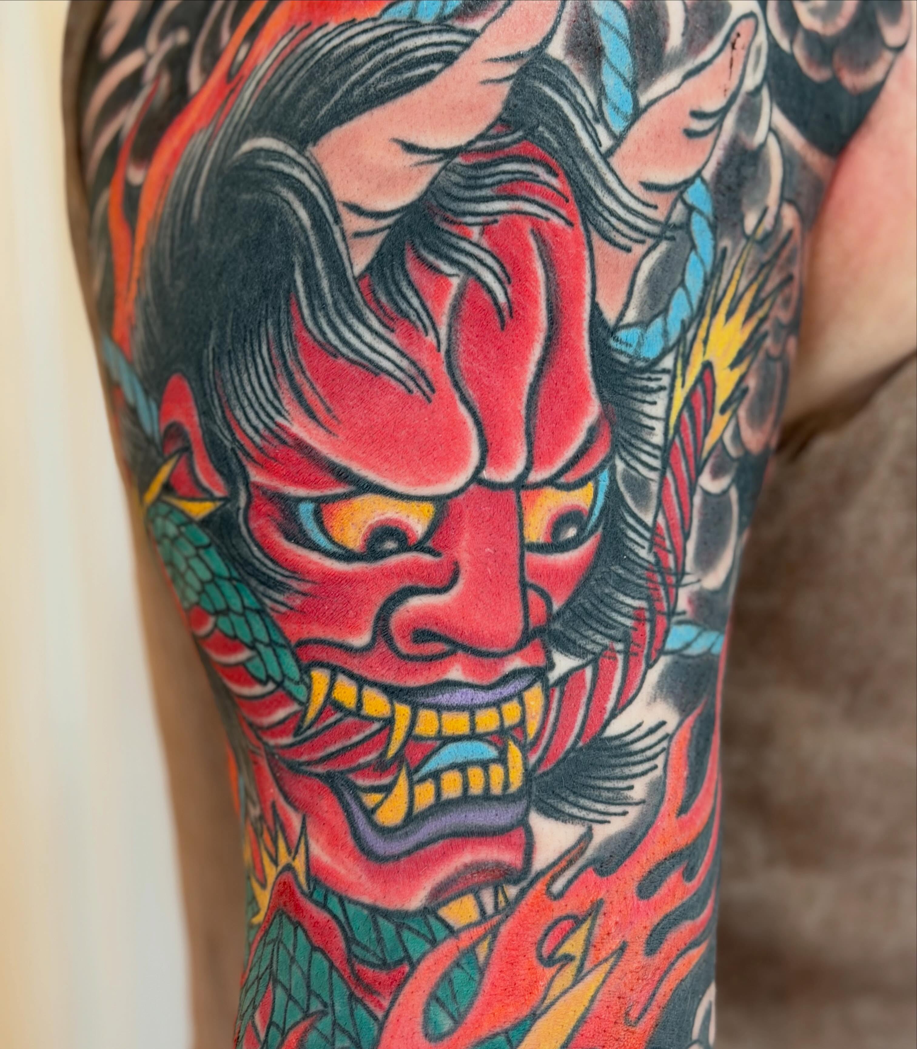 Demon mask American traditional tattoo on the forearm by Laura Saadati Kepper