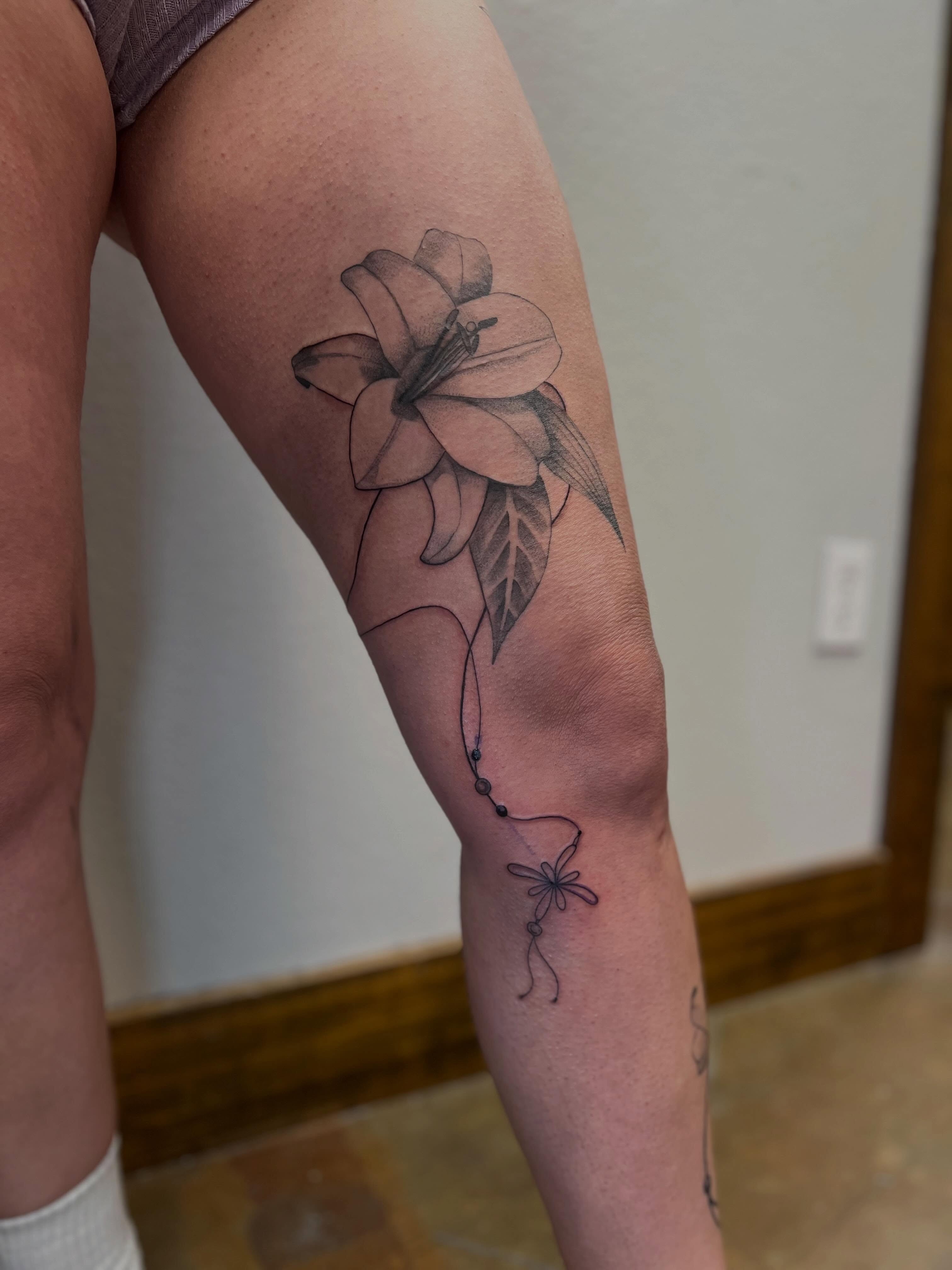 Lily black and grey tattoo on the forearm by Rebecca Kern Tattoos