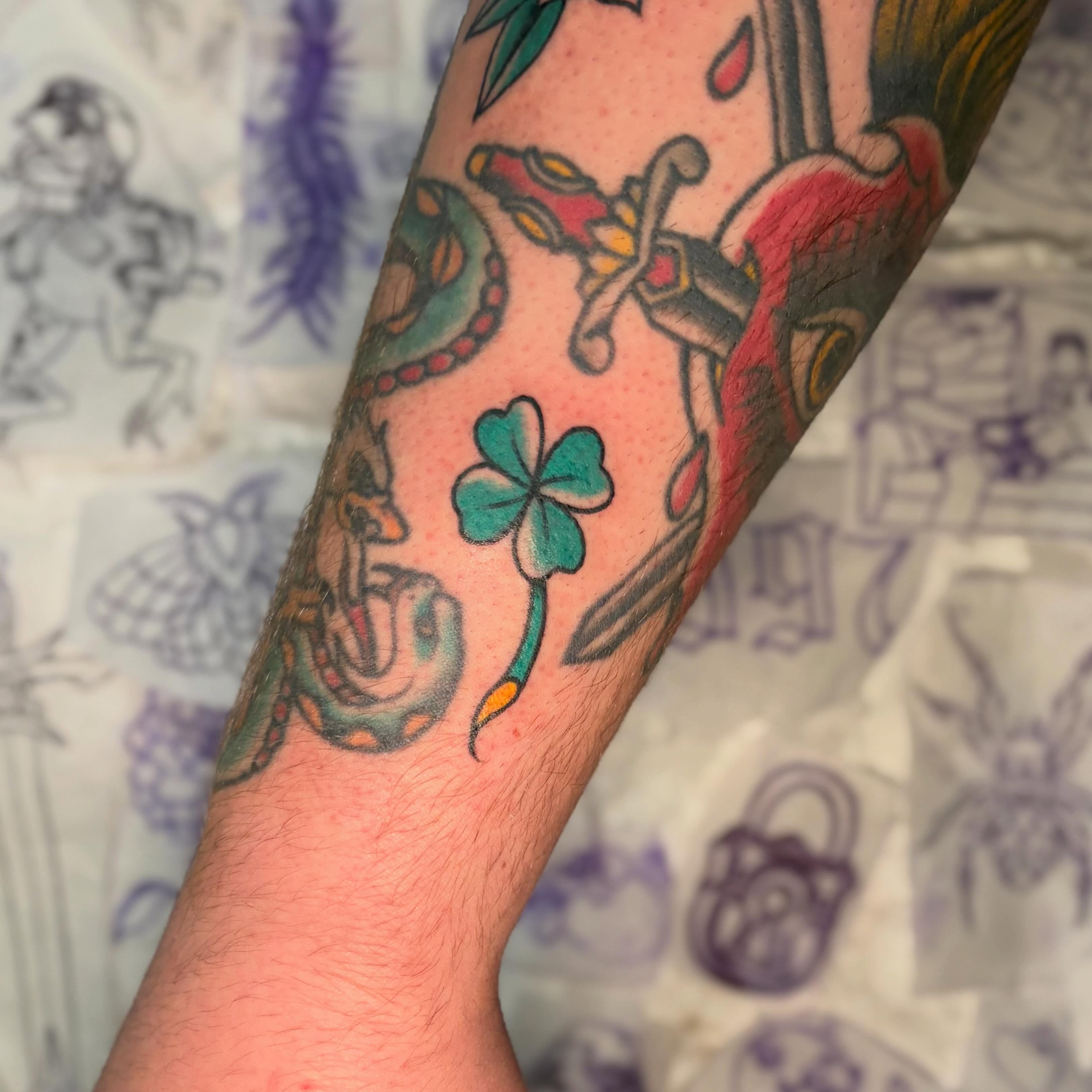 Clover and snake American traditional tattoo on the forearm by Danelle ✶ Nashville Tattooer