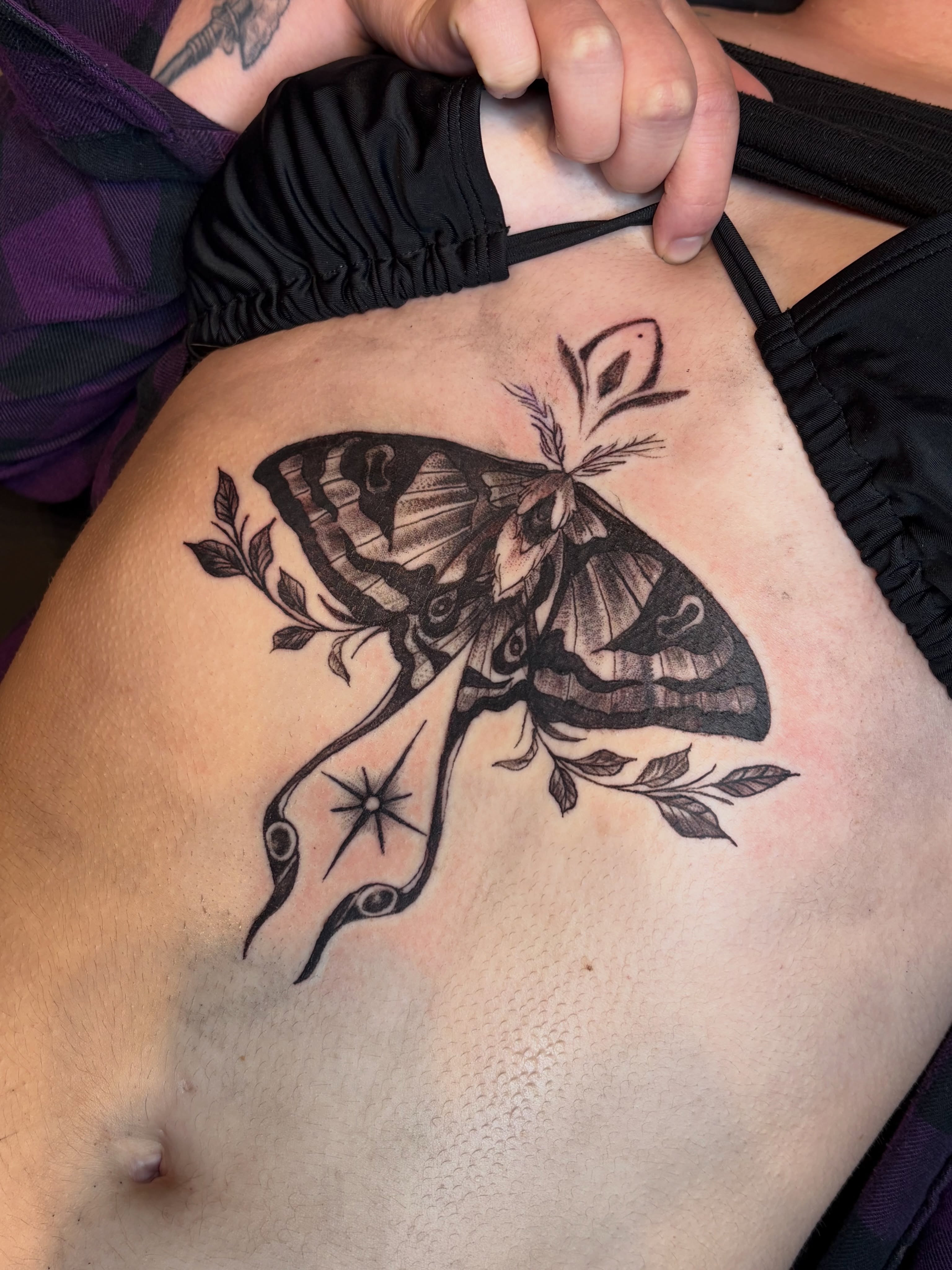 Moth and snake realism tattoo on the ribs by Calen Copeland