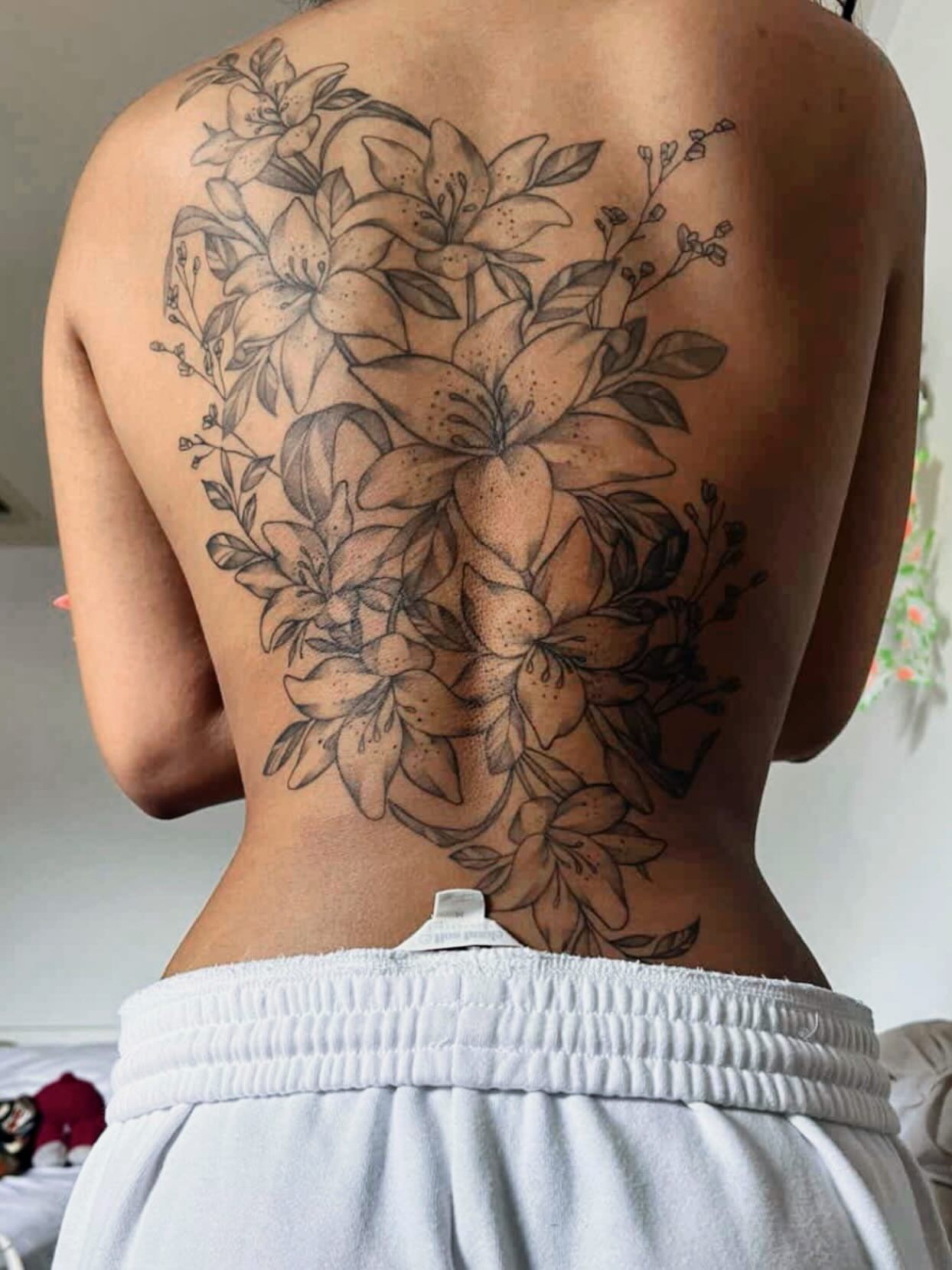 Lily bouquet black and grey tattoo on the back by Houston Tattoo🇺🇸👩🏻‍🎨💉