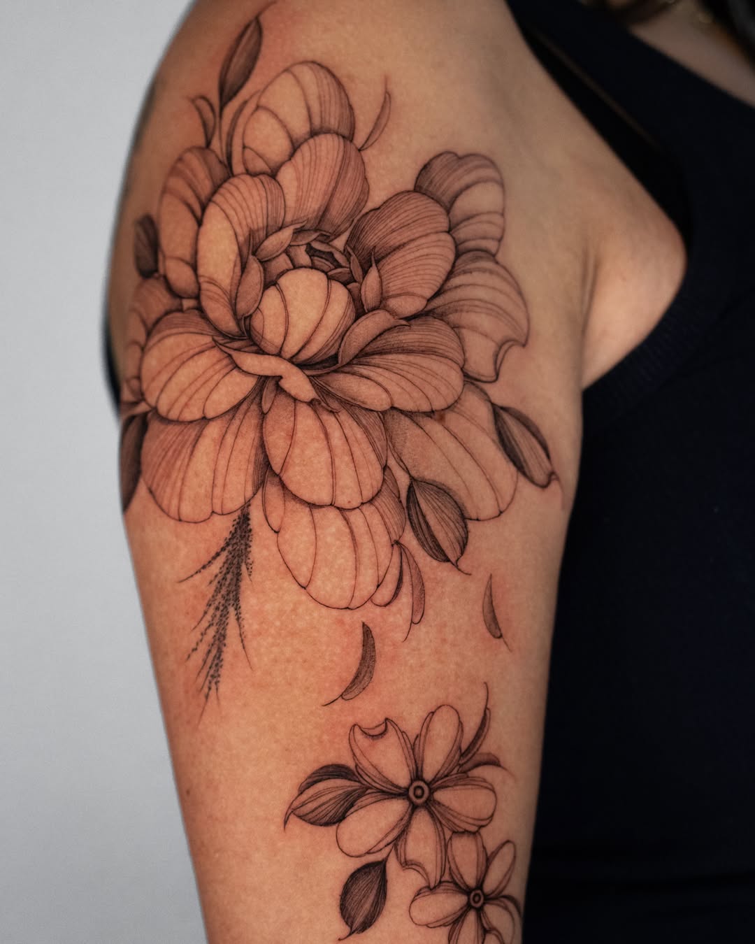 Flower black and grey tattoo on the shoulder by Tattoo fine line NY