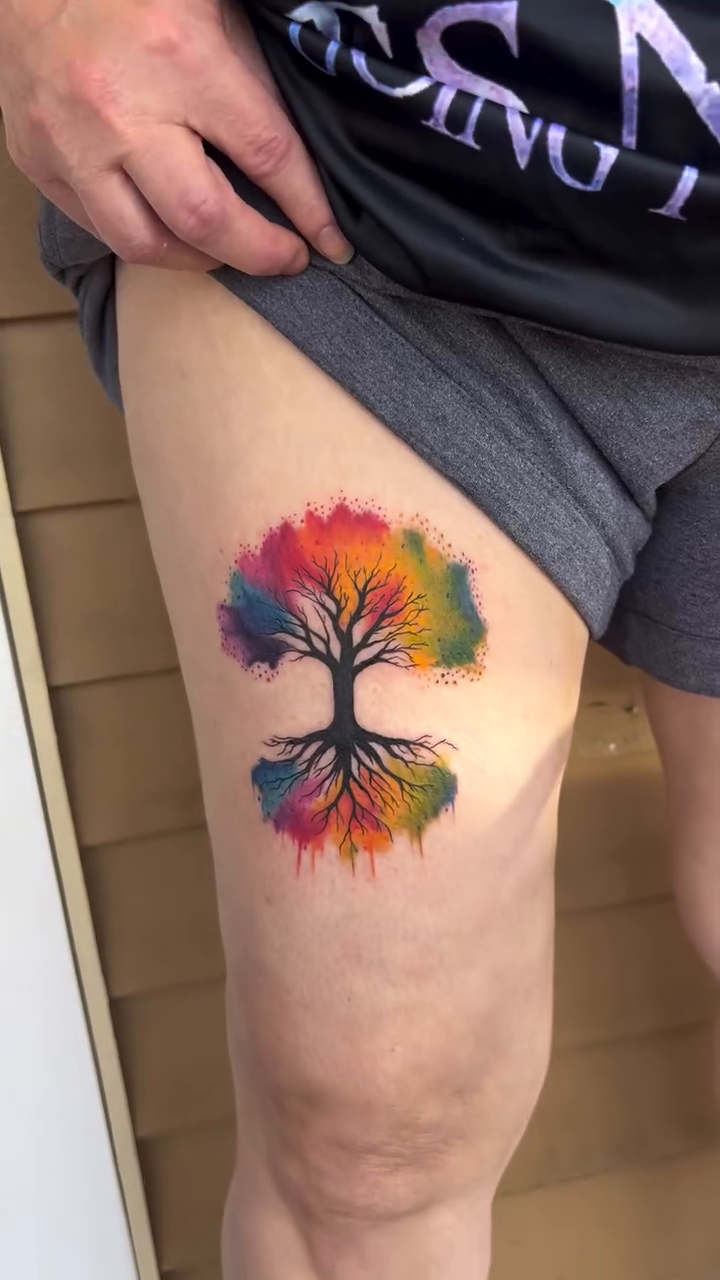 Rainbow tree of life watercolor tattoo on the forearm by Jai Woods