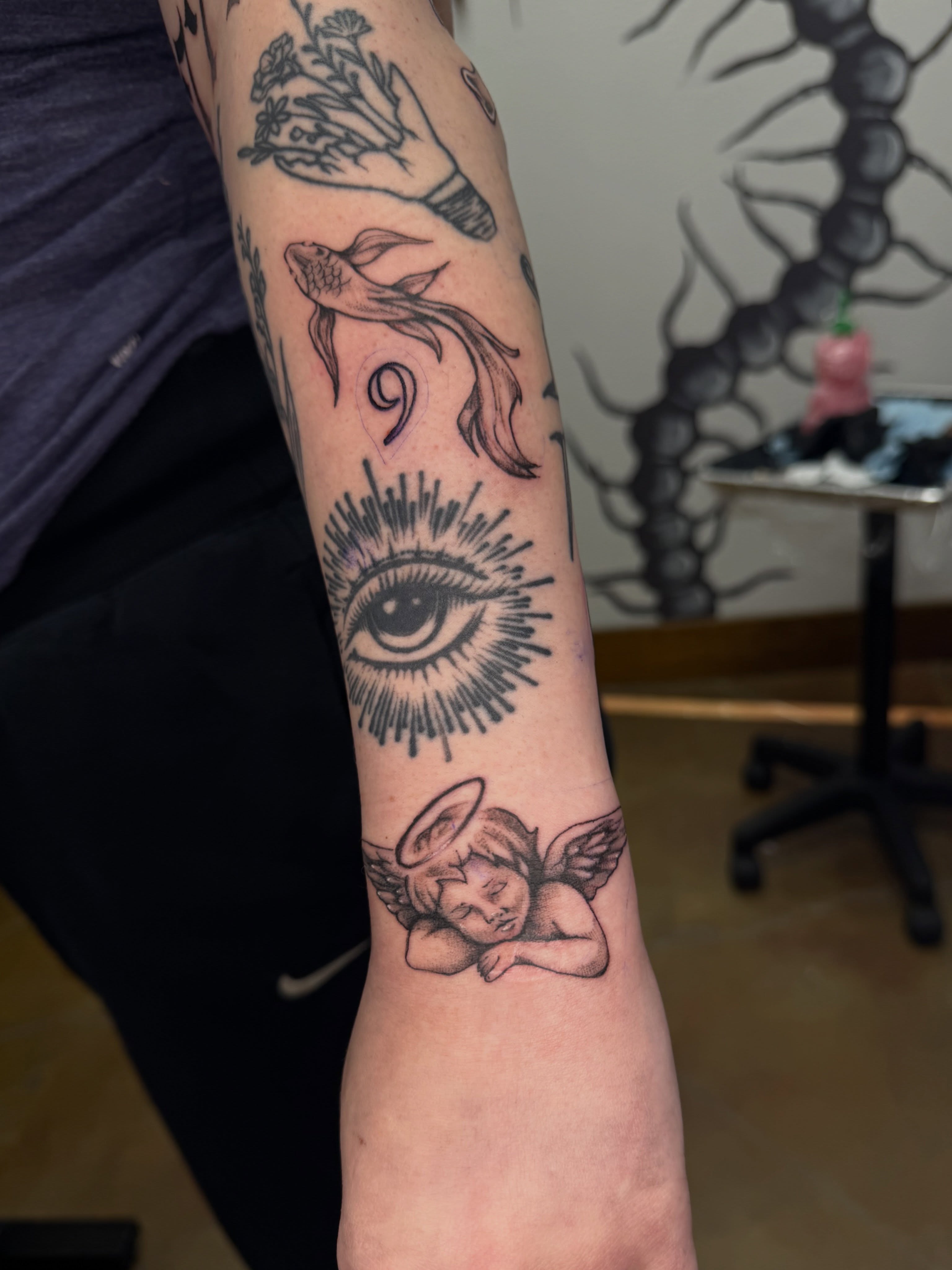 Angel with halo neo-traditional tattoo on the forearm by Halle Cooper
