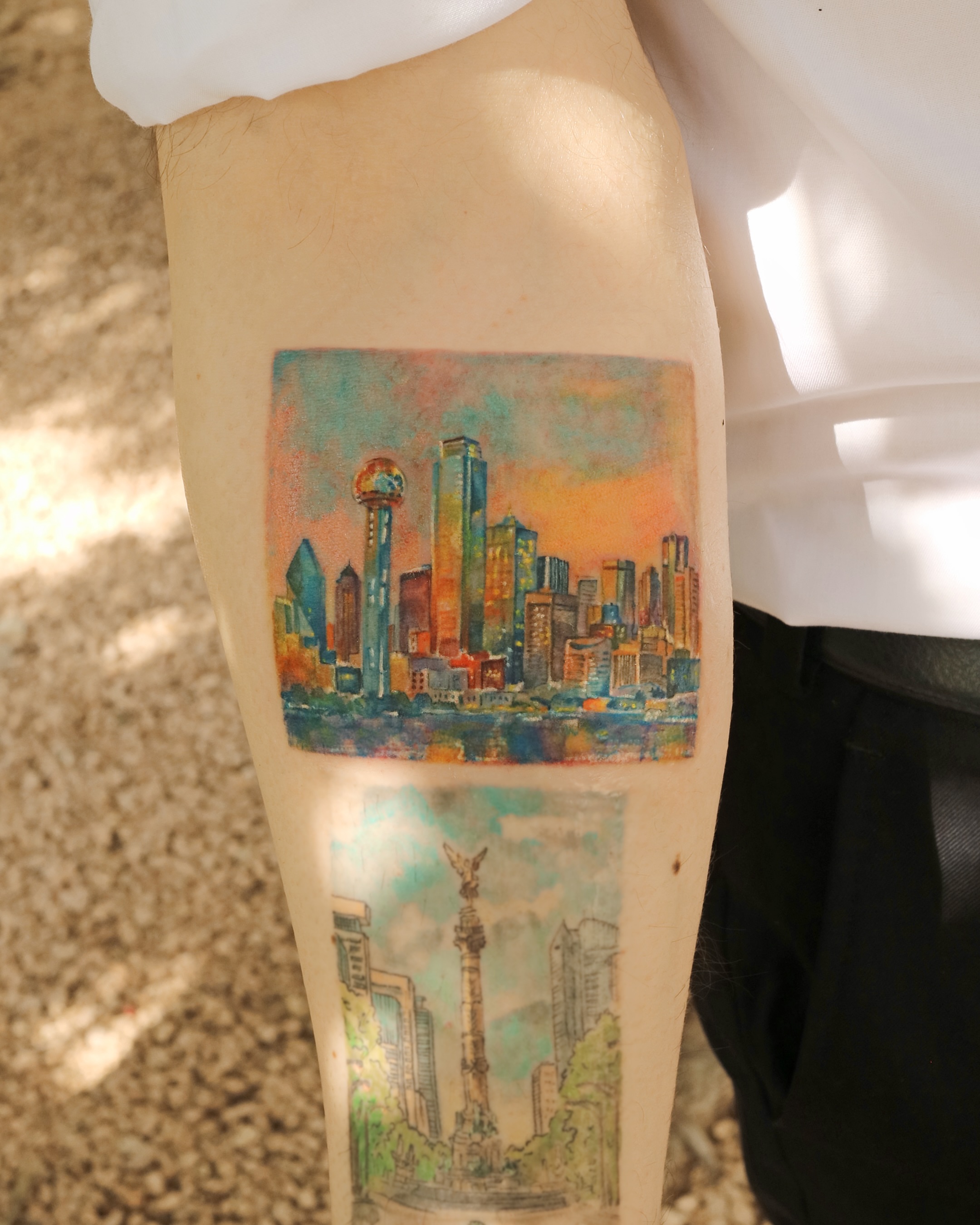 Cityscape watercolor tattoo on the forearm by Aroha