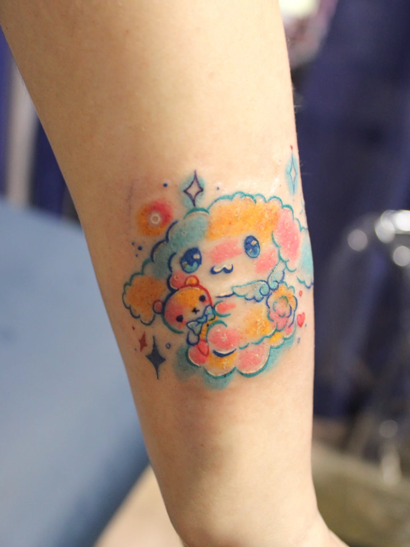 Kawaii character watercolor tattoo on the forearm by Sonder