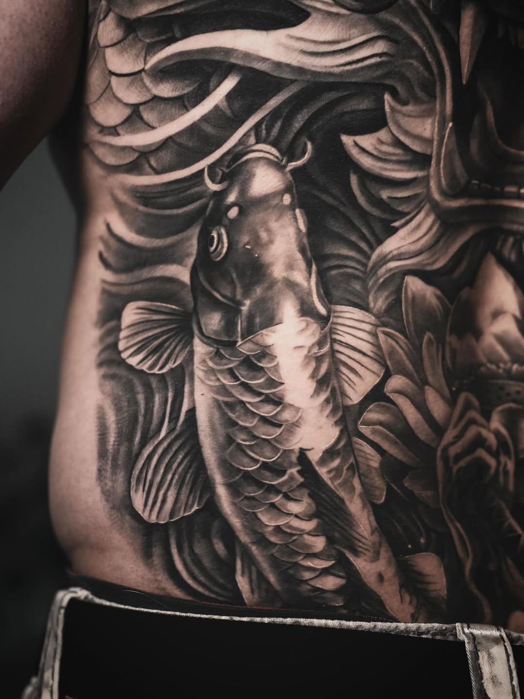 Koi fish and dragon Japanese tattoo on the torso by Claude Steven Estrada, Las Vegas, Nevada