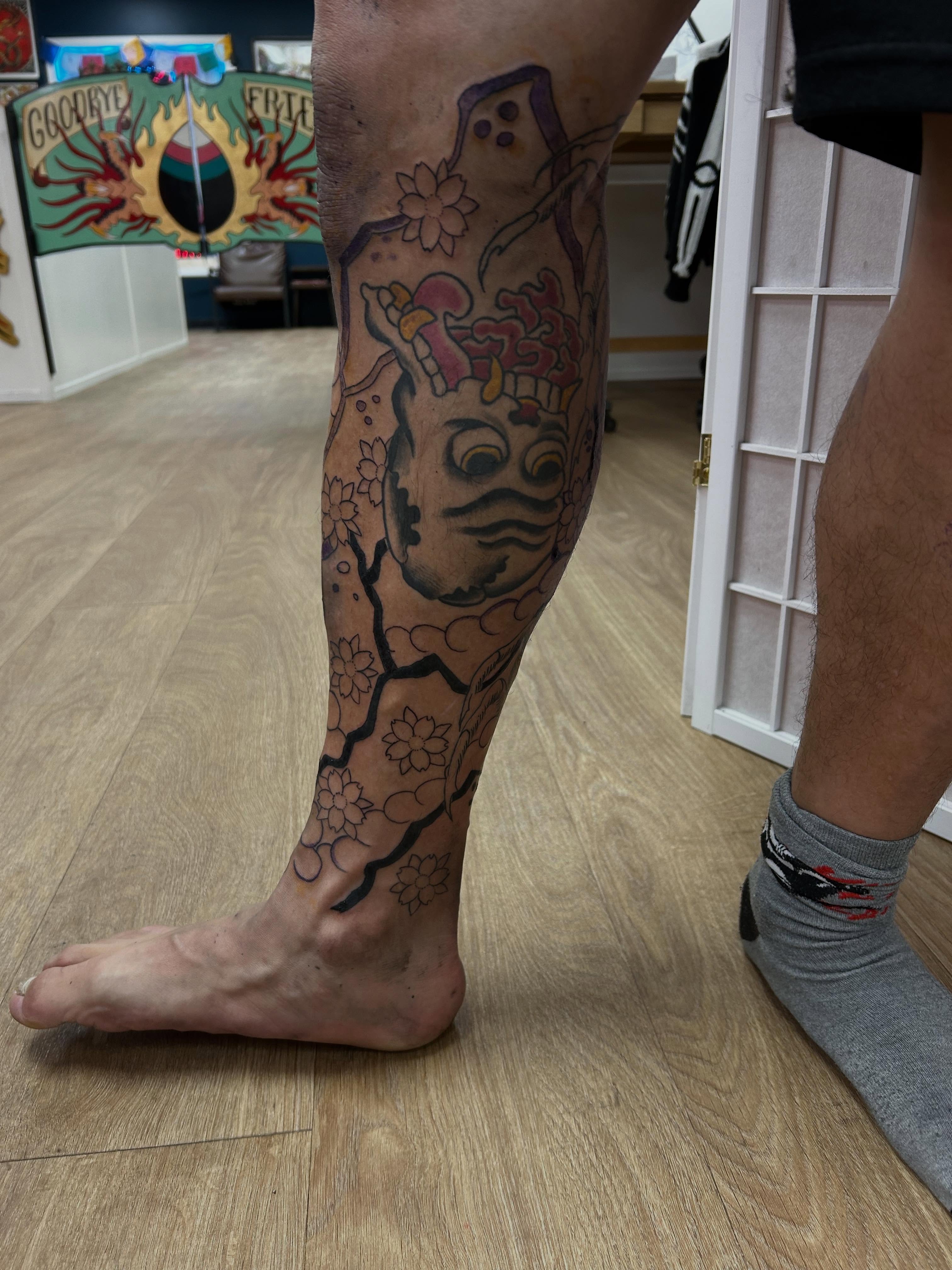 Mask with flowers japanese irezumi tattoo on the calf by Stogie Tony