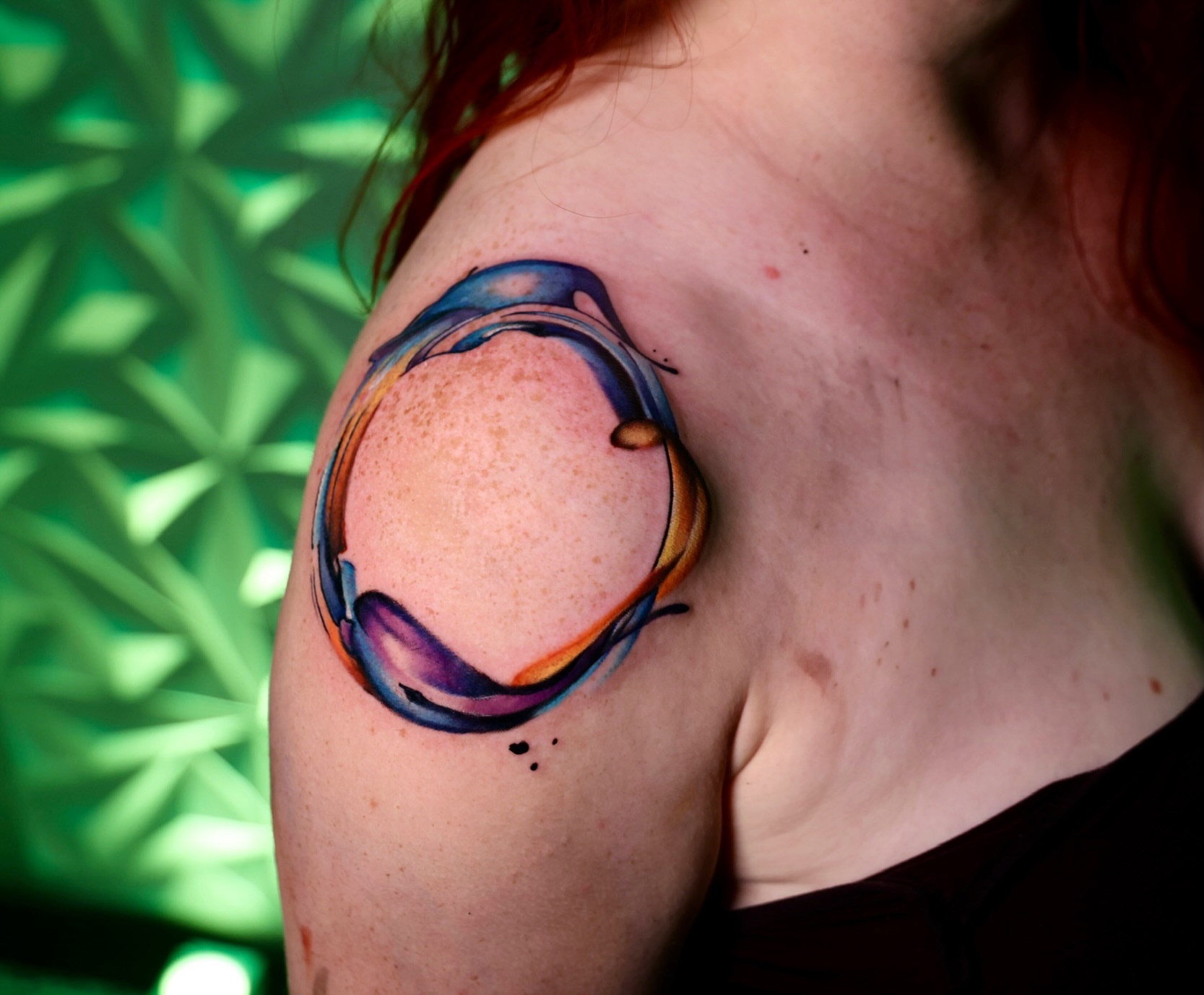 Abstract sphere watercolor tattoo on the shoulder by Haleigh Cunningham, Charlotte, North Carolina