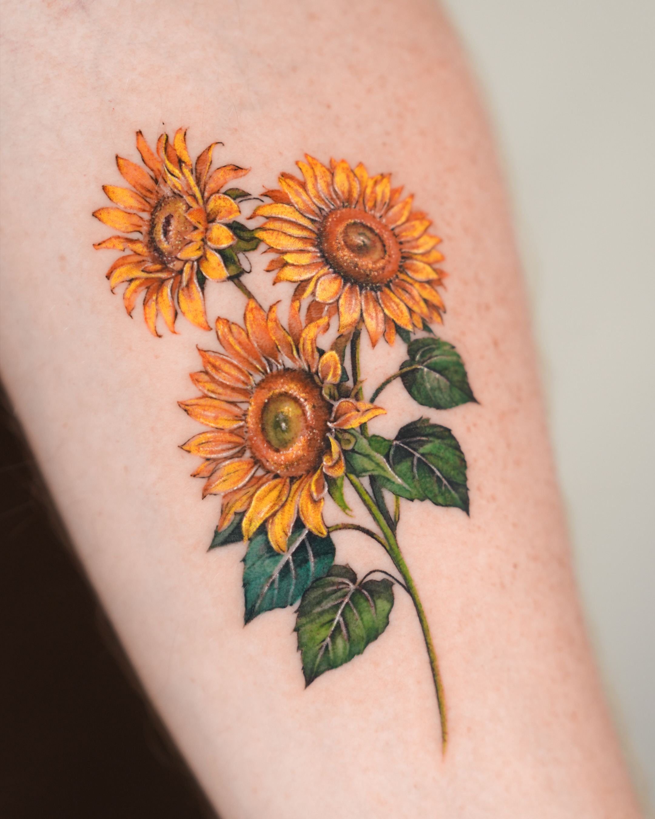 Sunflowers realism tattoo on the forearm by YUN