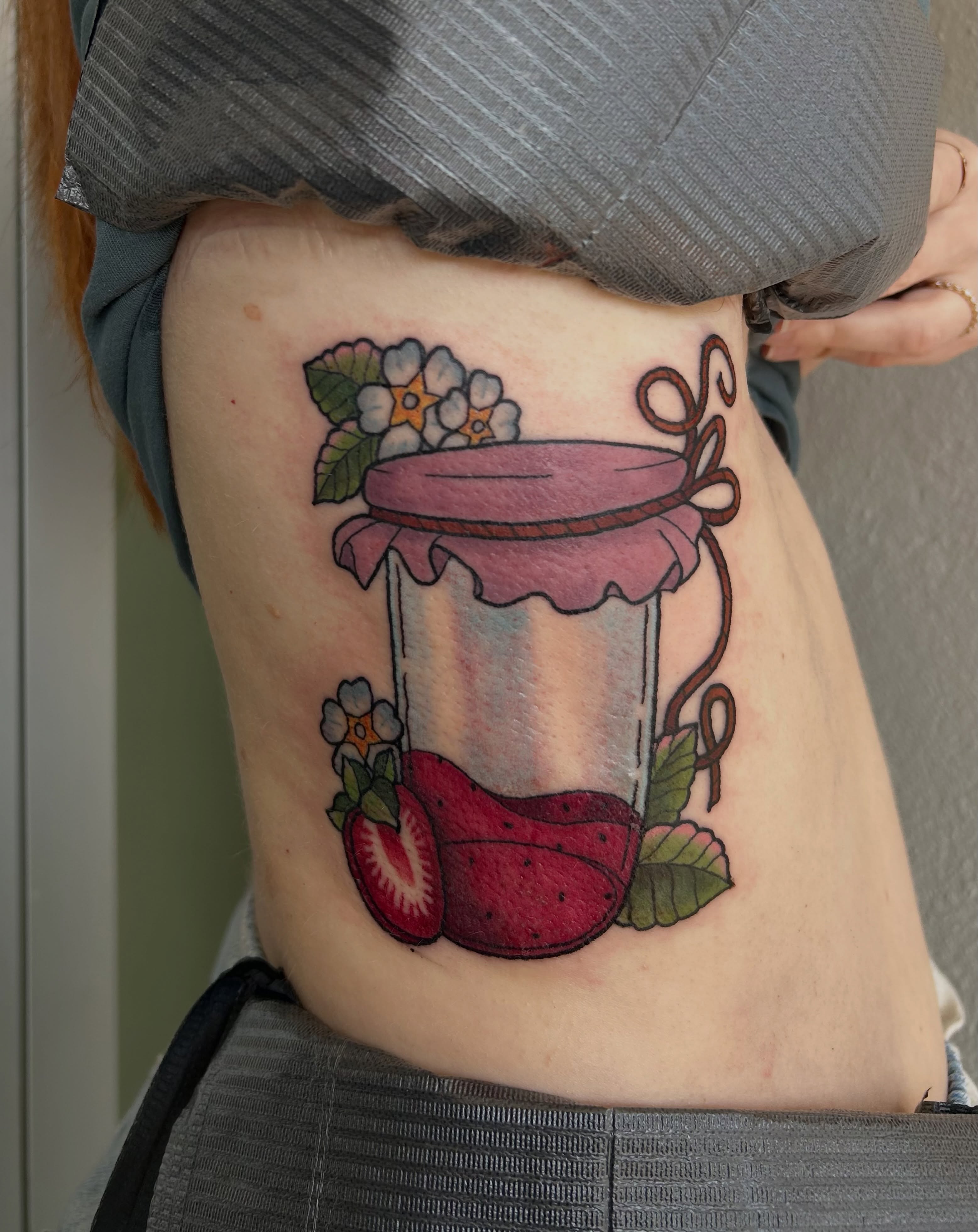 Strawberry jam jar American traditional tattoo on the ribs by Courtney