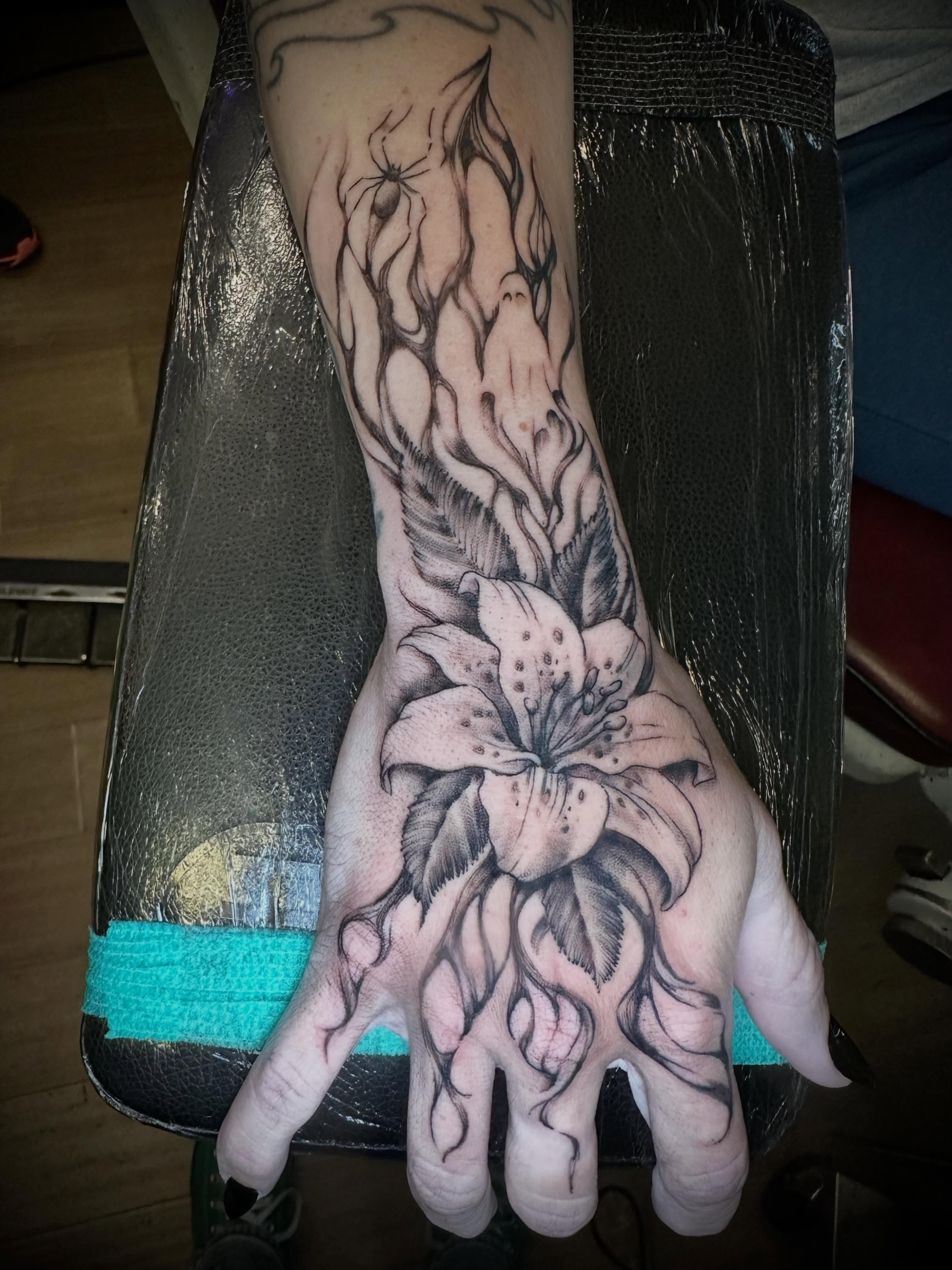 Lily black and grey tattoo on the hand by Alan