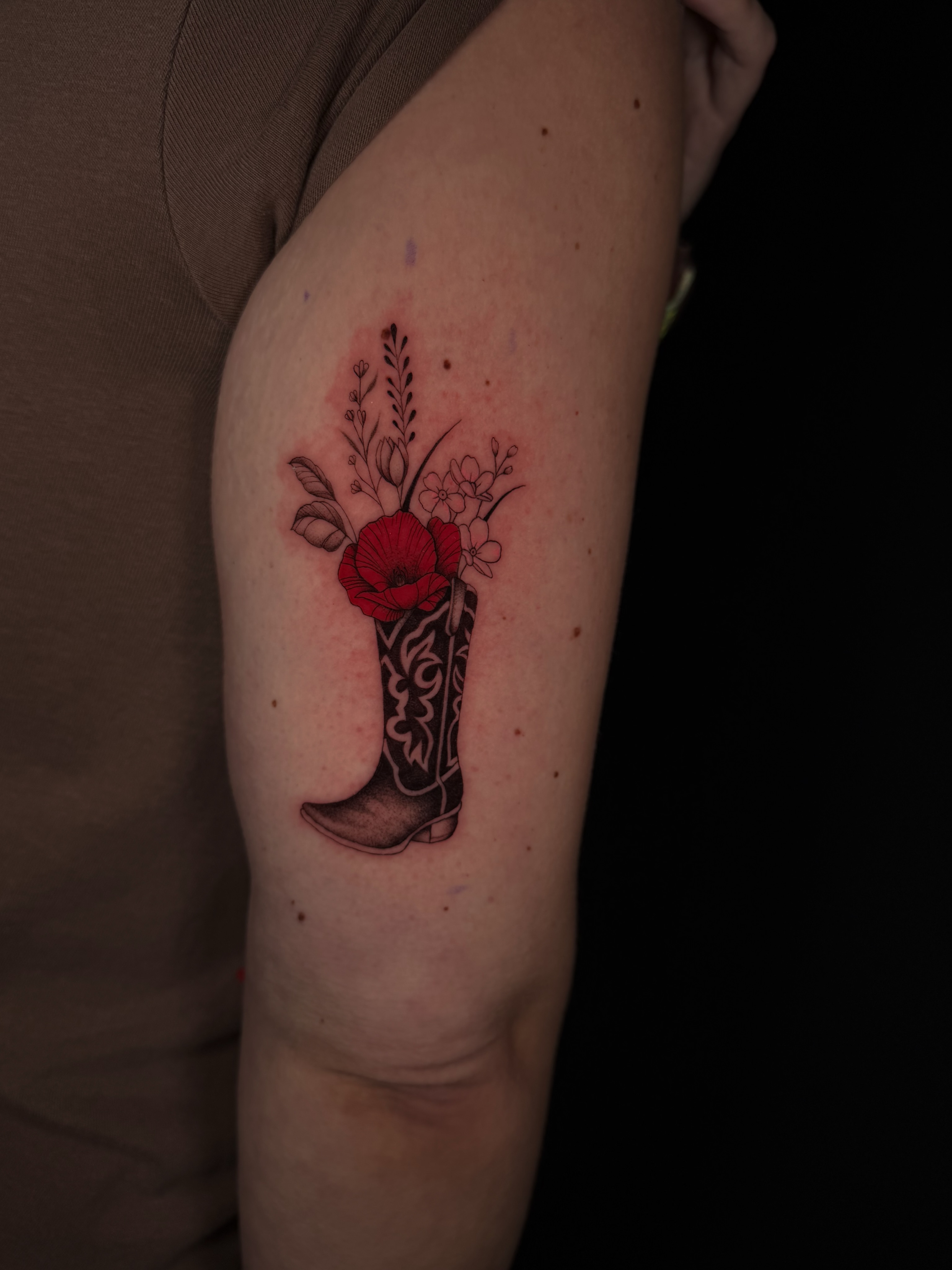 Cowboy boot with flowers American traditional tattoo on the forearm by Marianne