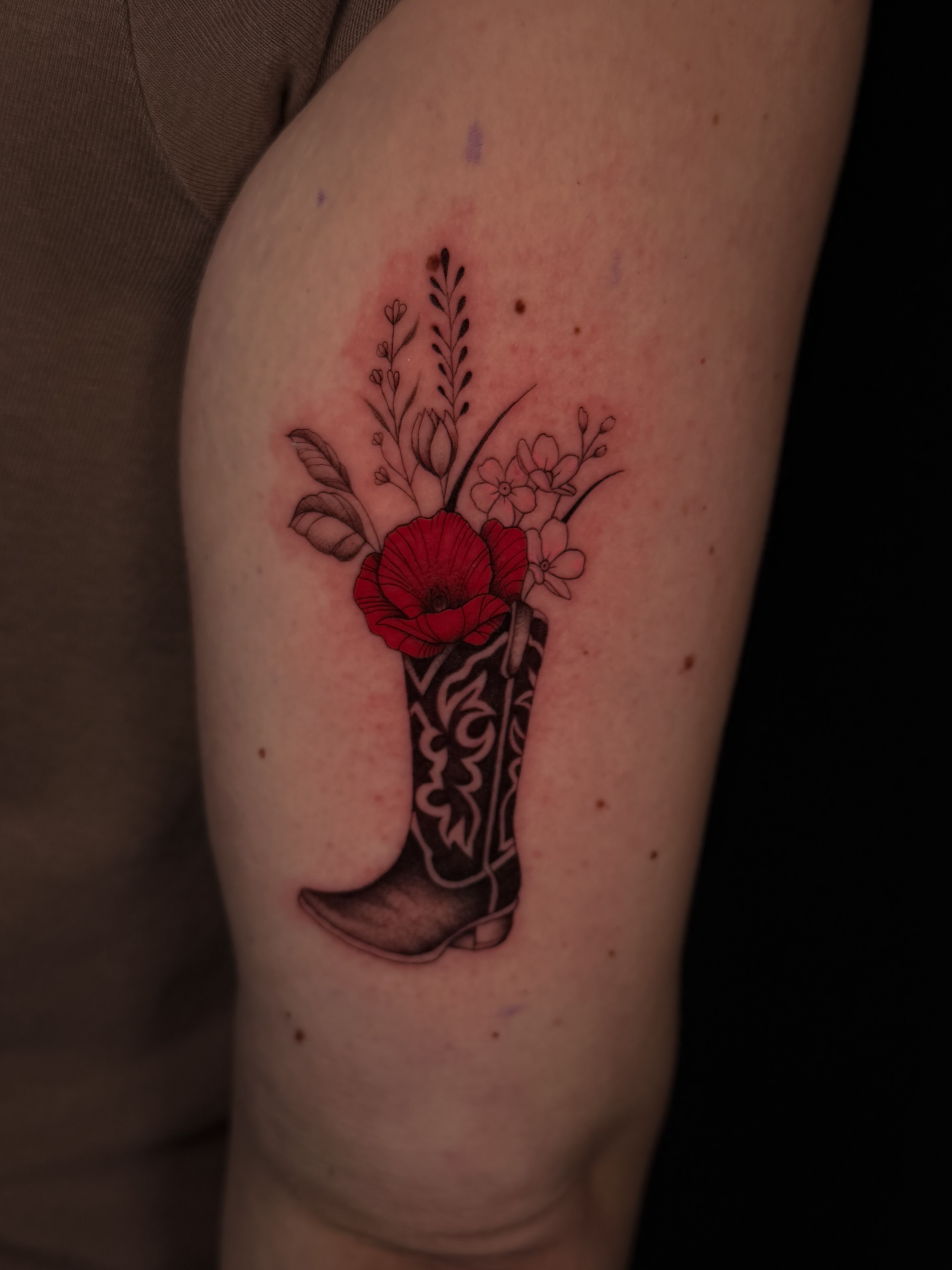 Cowboy boot with flowers American traditional tattoo on the forearm by Marianne