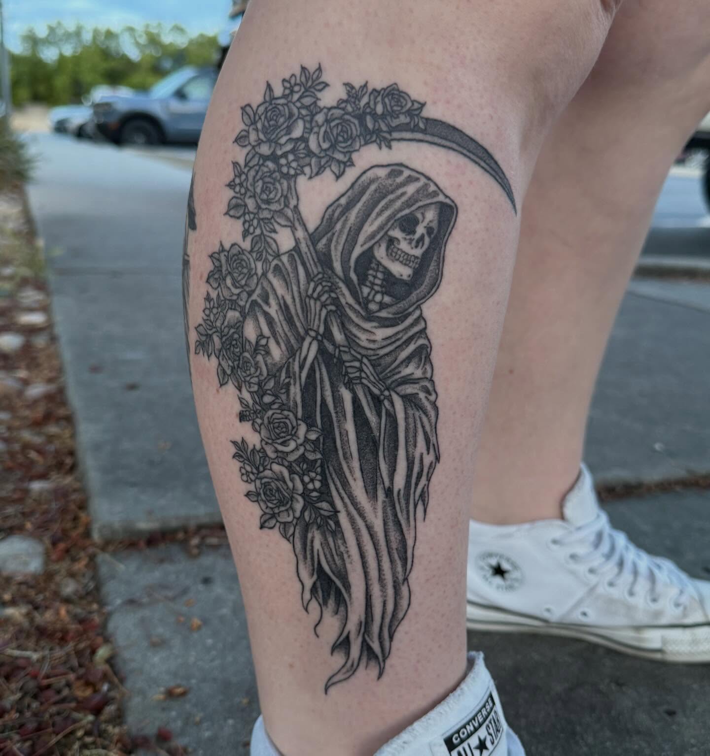 Grim reaper black and grey tattoo on the thigh by Elena