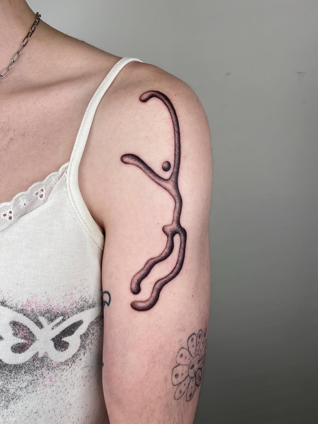 Abstract figure blackwork tattoo on the upper arm by sid or sir, whatever u prefer