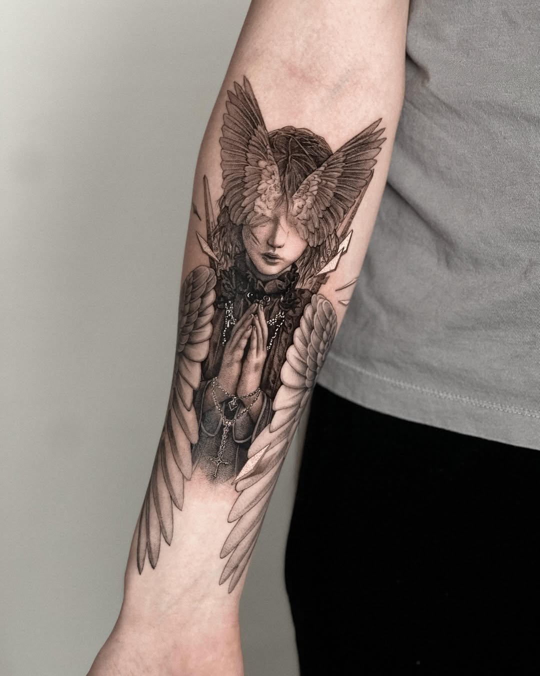 Angelic figure with wings realism tattoo on the forearm by Taras Vandzharuk