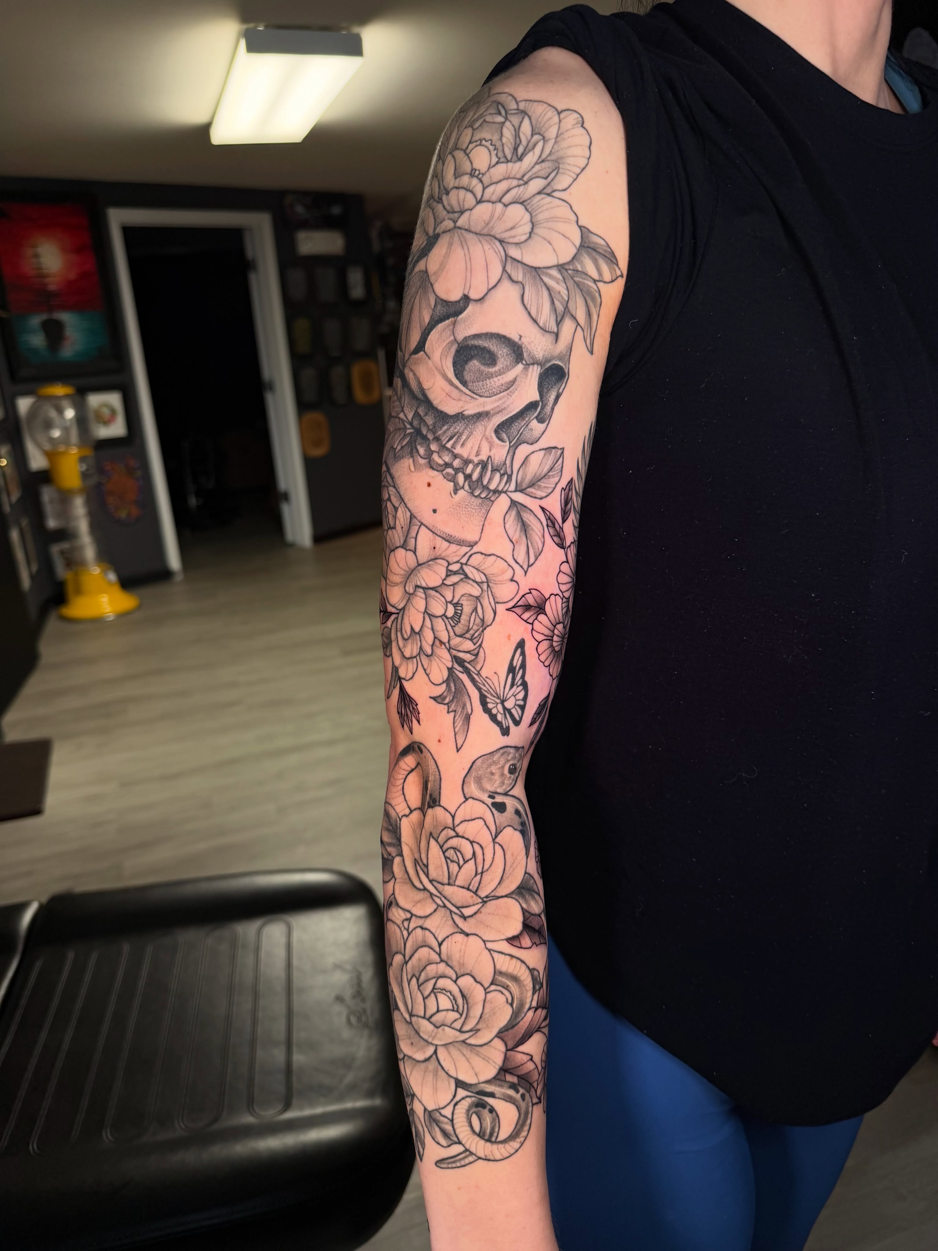 Floral skull black and grey tattoo on the forearm by Beau Zeis