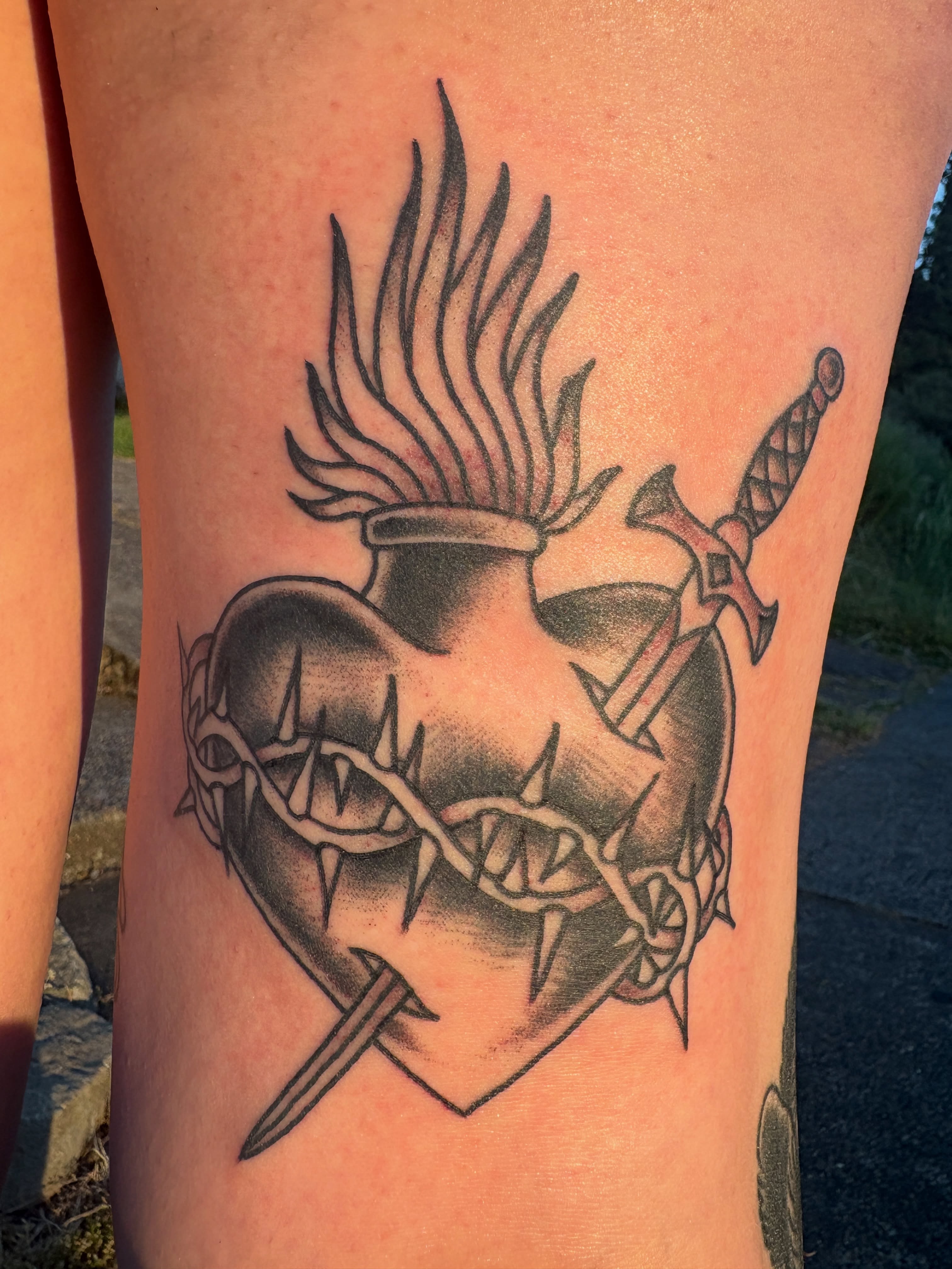 Heart and crown of thorns realism tattoo on the thigh by Kimber Teatro, Portland, Oregon