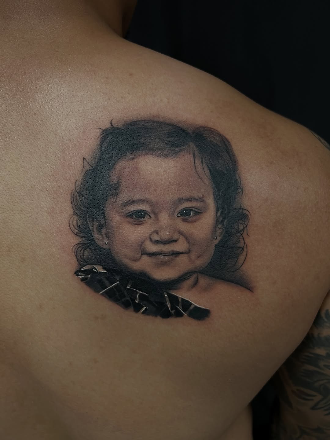 Portrait of a baby realism tattoo on the shoulder by Thomas Conard