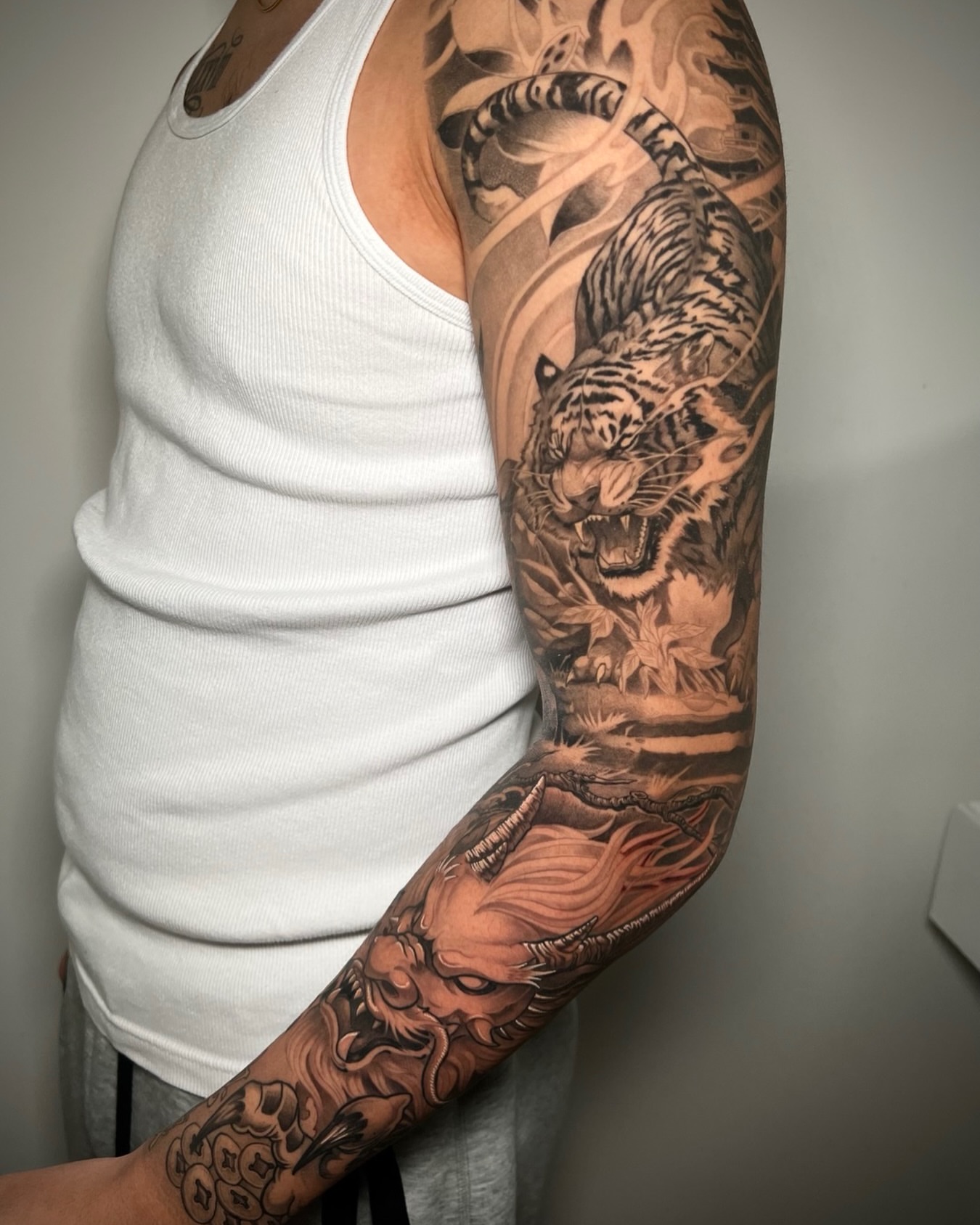 Tiger and dragon japanese irezumi tattoo on the upper arm by Johnson