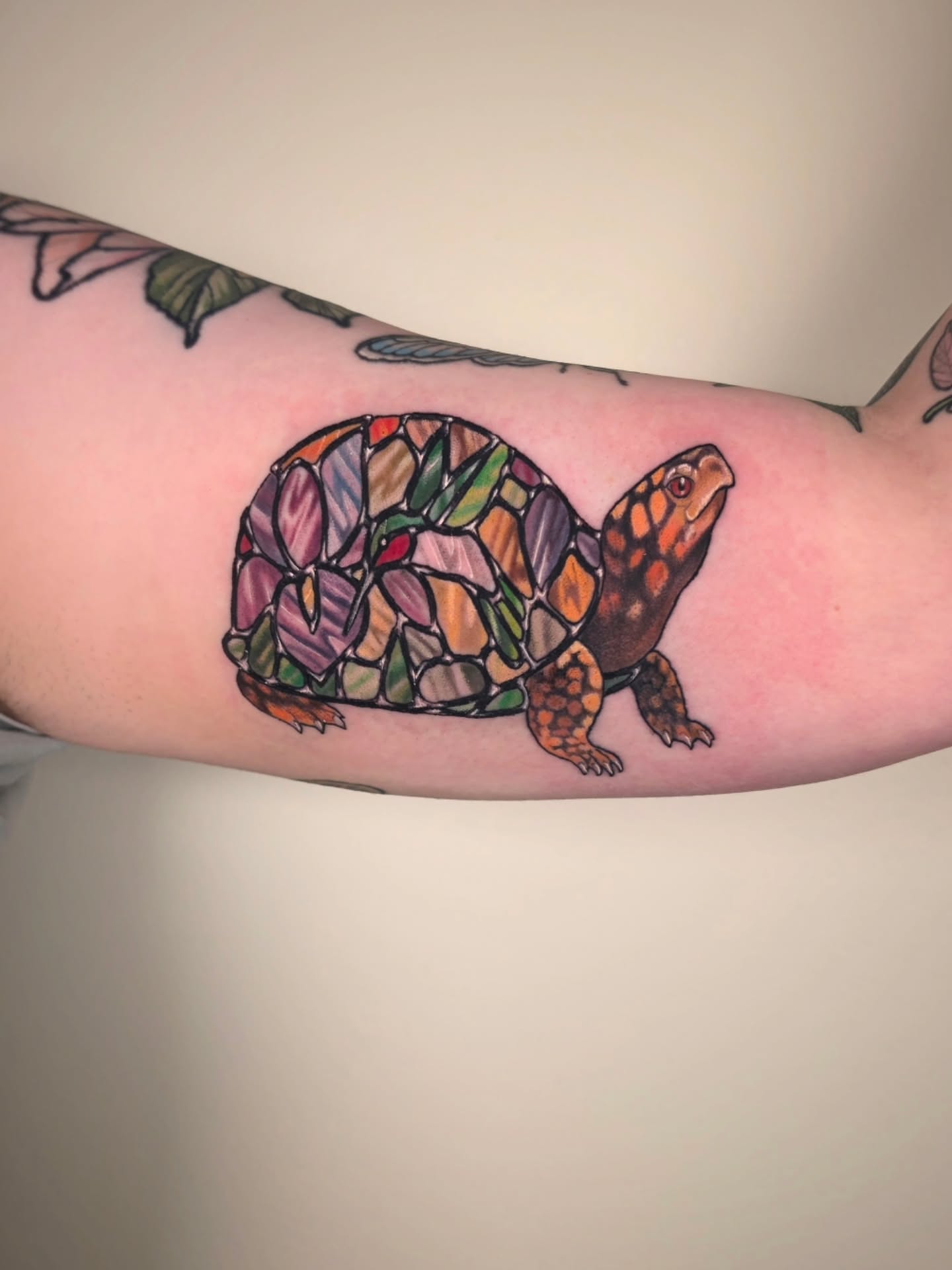 Stained glass turtle geometric tattoo on the forearm by Whitney Caskey