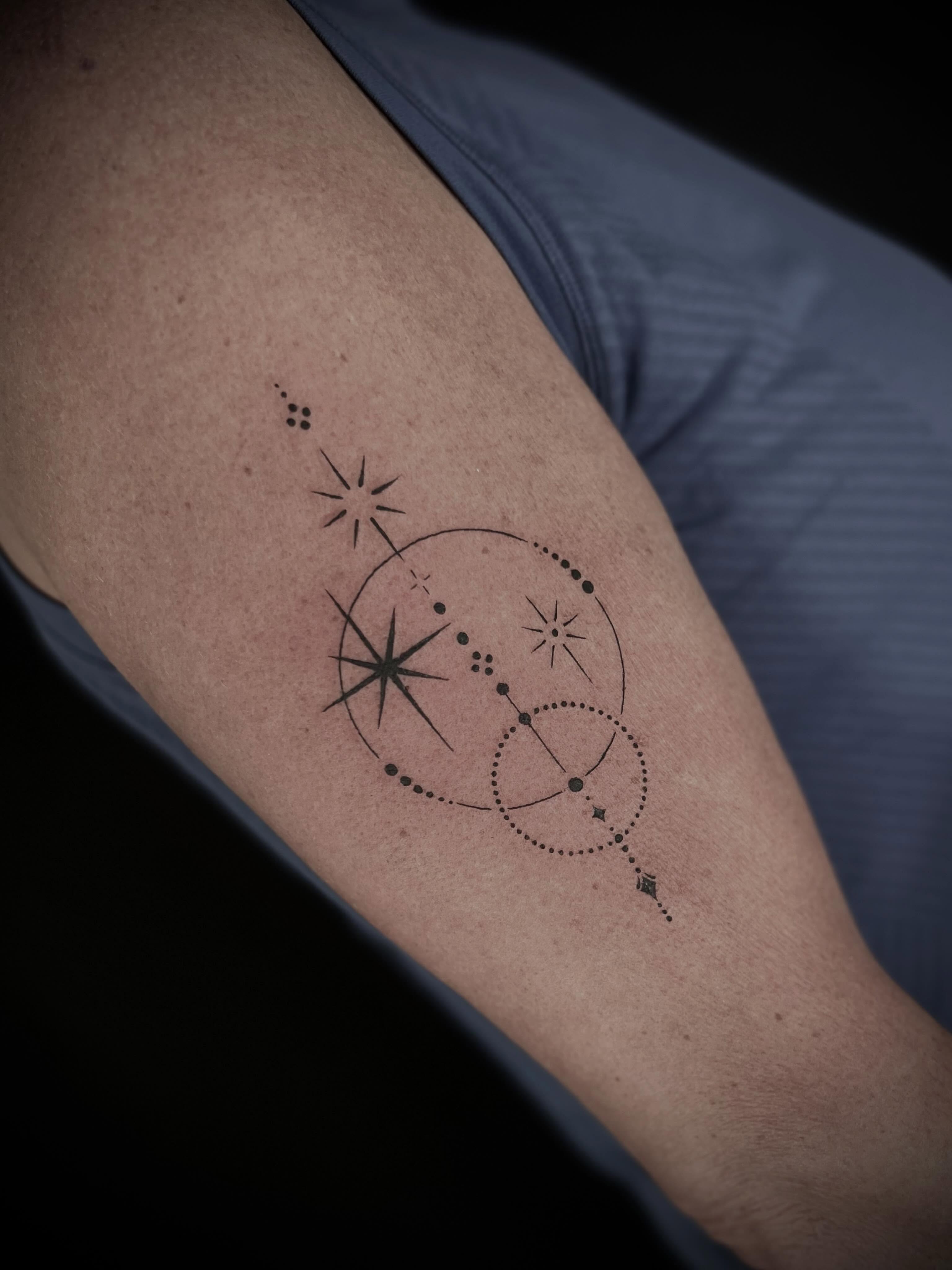 Geometric celestial design dotwork tattoo on the forearm by Lexi Rose
