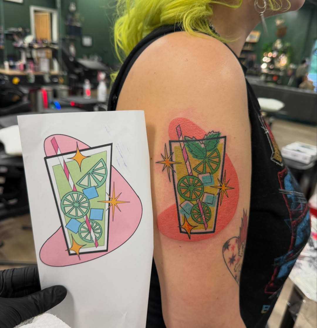 Cocktail drink new school tattoo on the upper arm by CAT