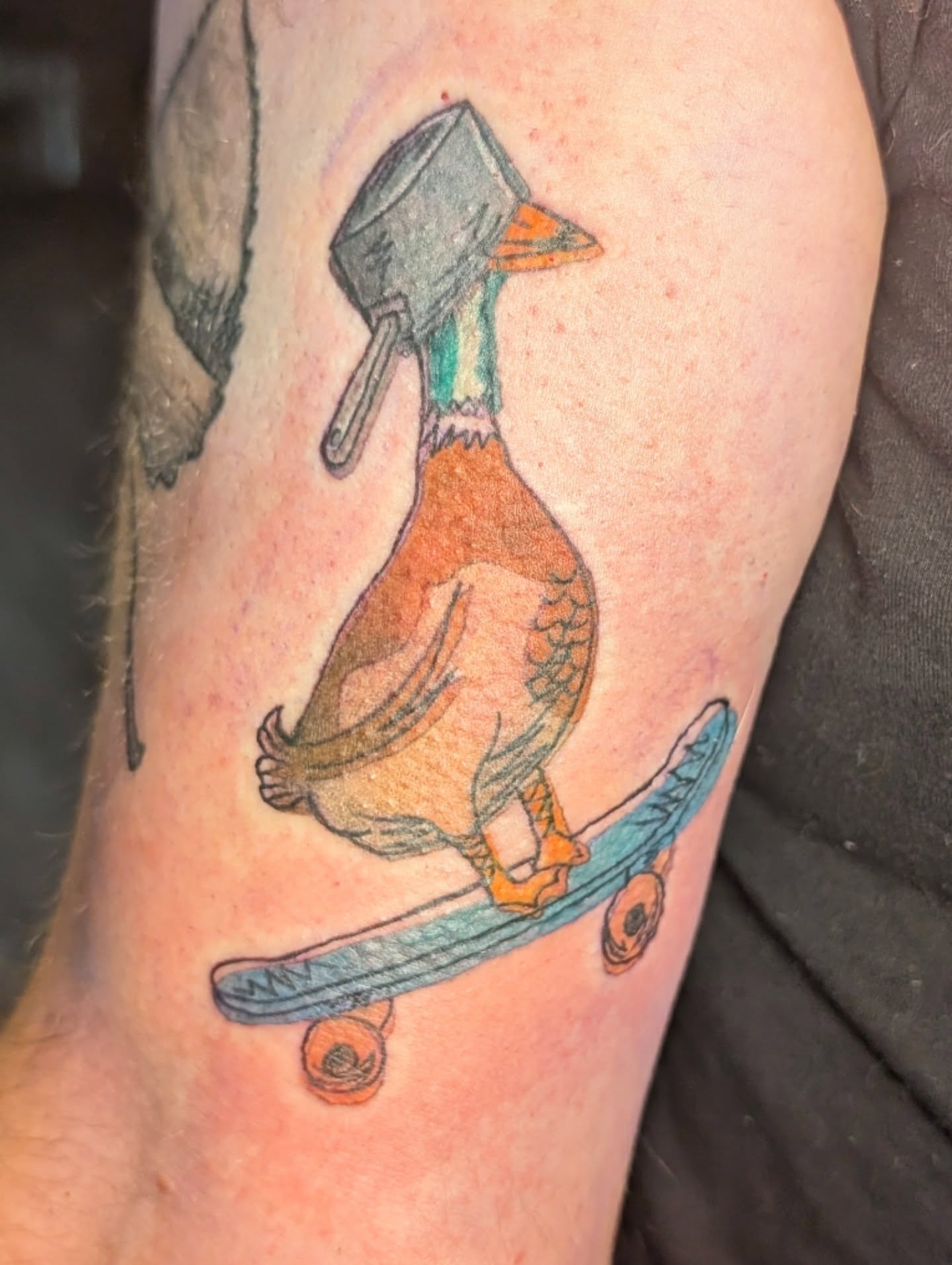 Duck on skateboard American traditional tattoo on the forearm by Michaela May